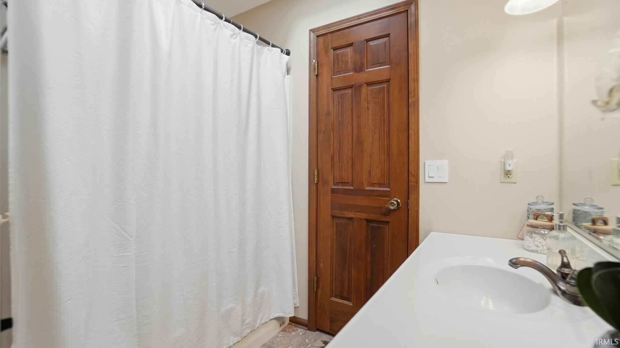 Full bathroom with a shower with curtain and vanity