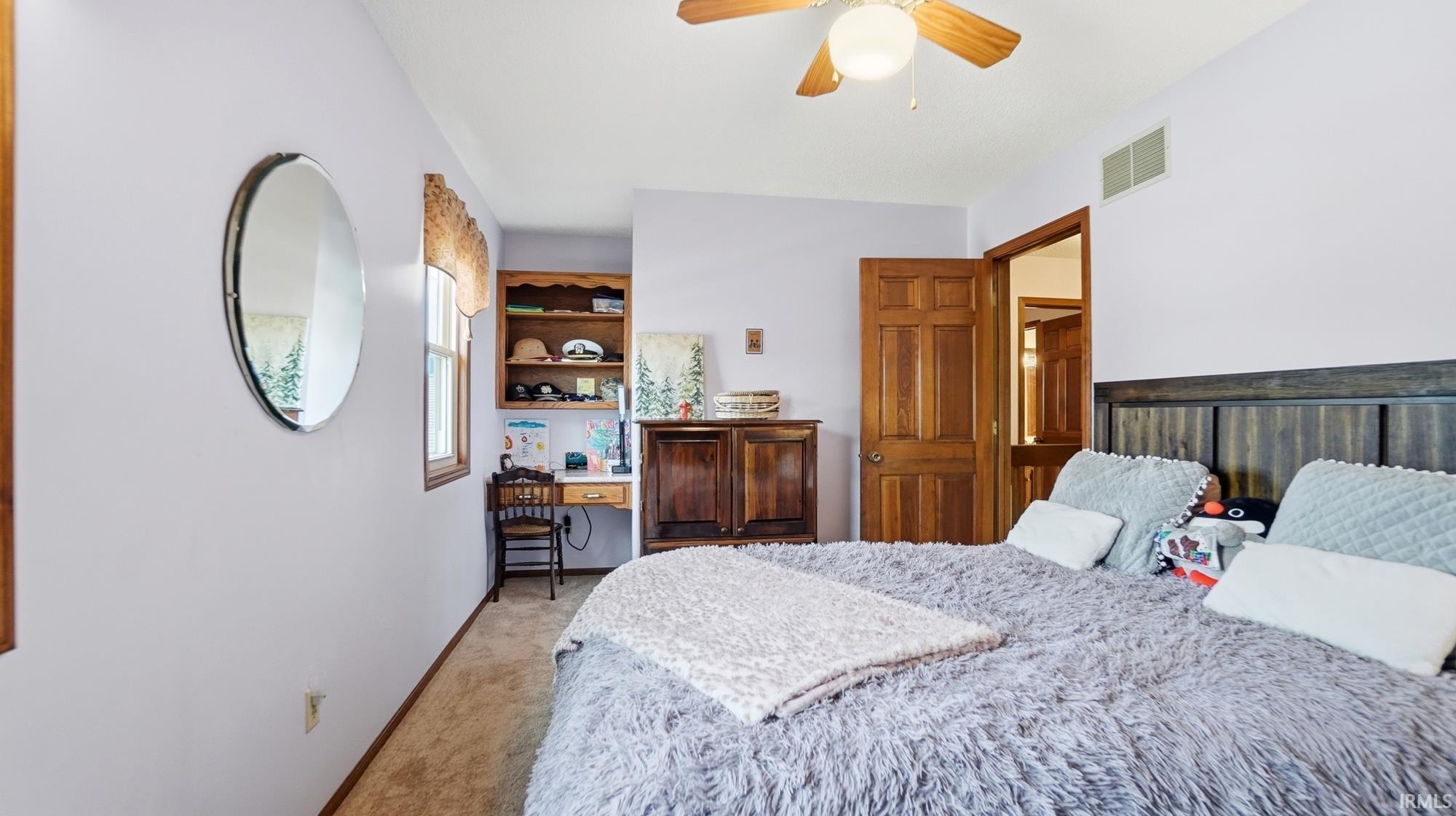 Bedroom with carpet floors and ceiling fan