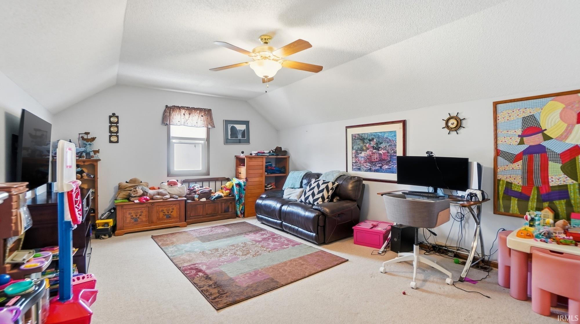 Living room featuring carpet floors and ceiling fan