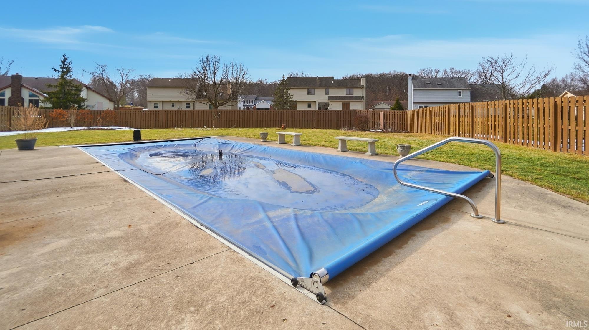 View of pool with a fenced backyard, a residential view, and patio surround