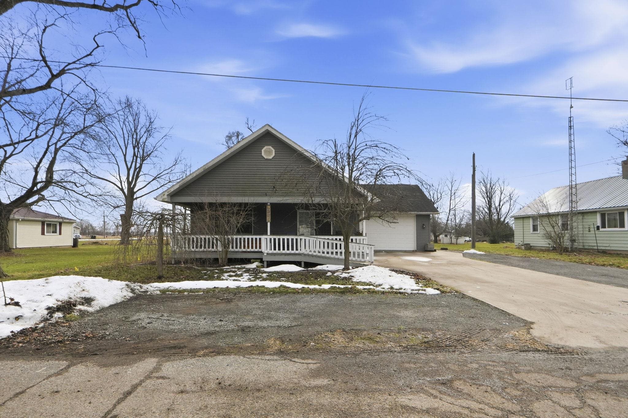 View of front of property with driveway and a porch