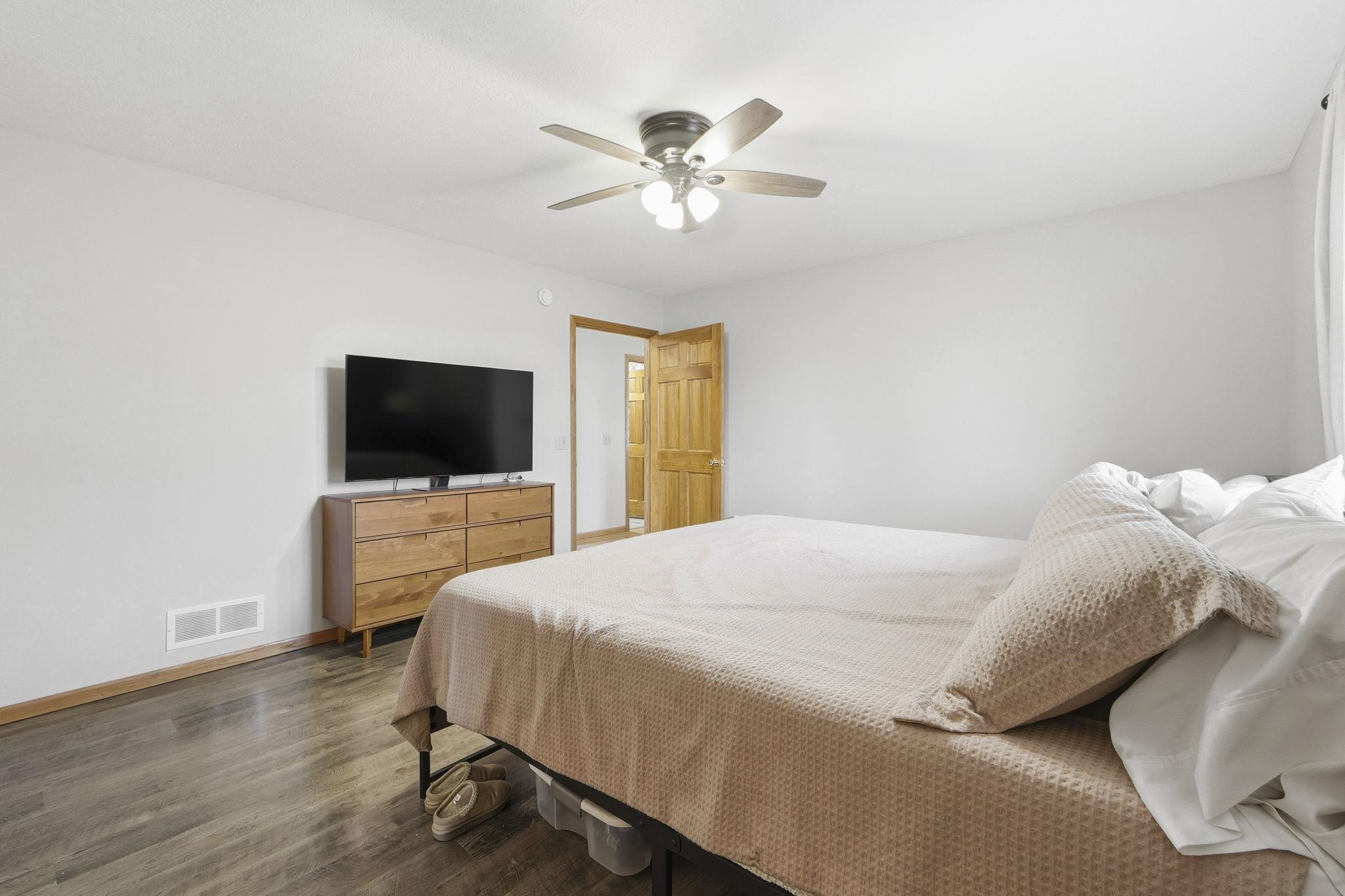 Bedroom with wood finished floors and ceiling fan