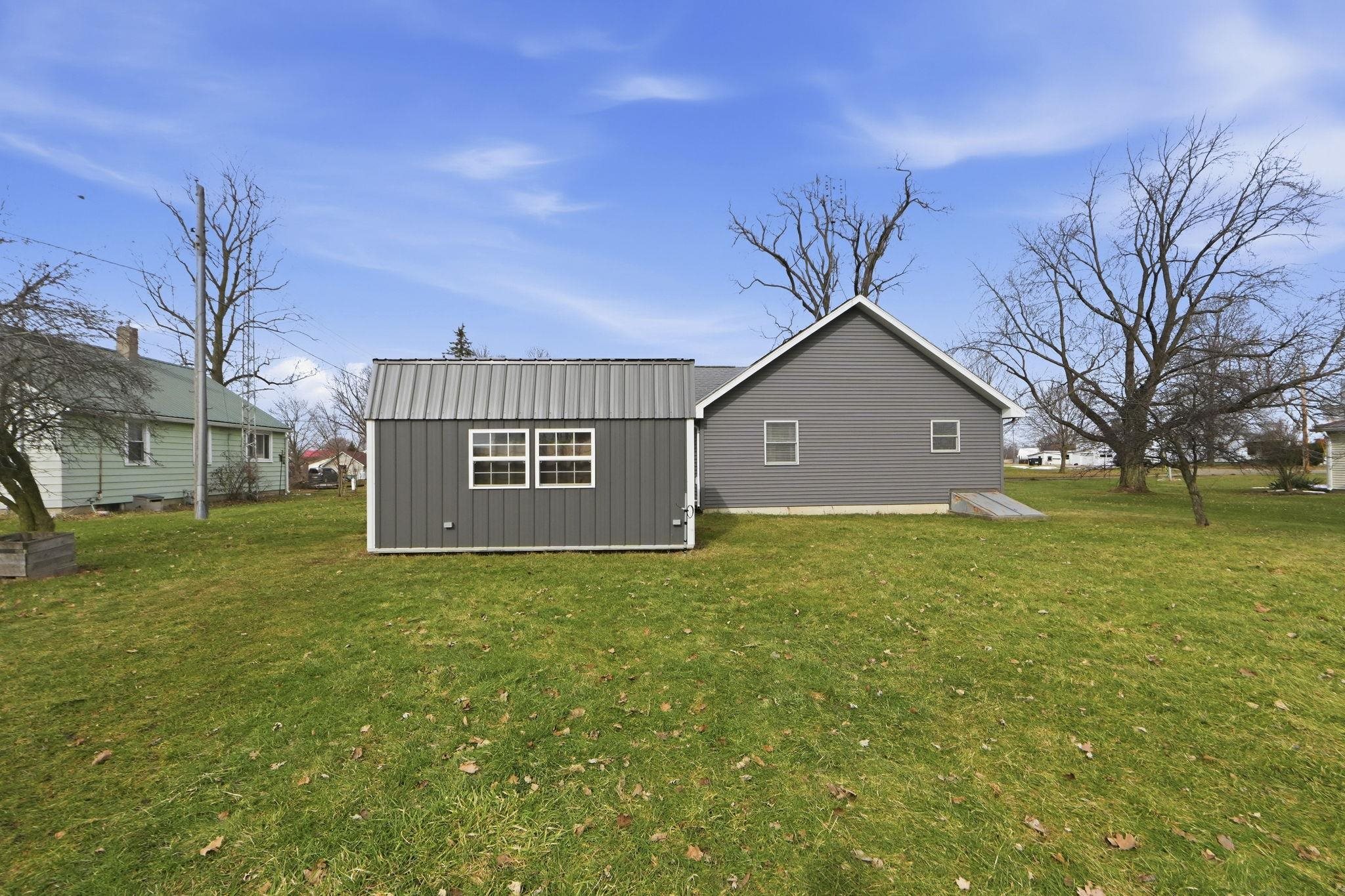 Rear view of house featuring a yard and board and batten siding