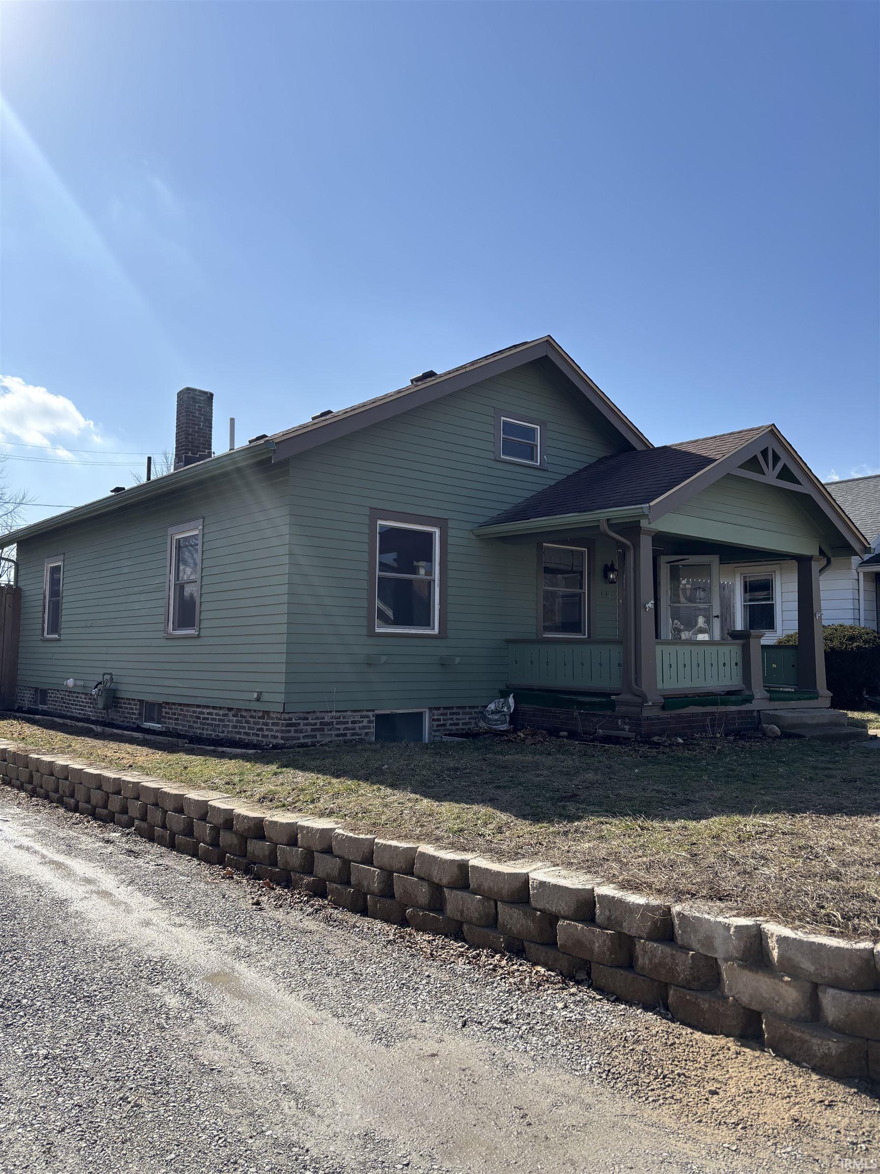 View of front of property featuring a porch and a chimney