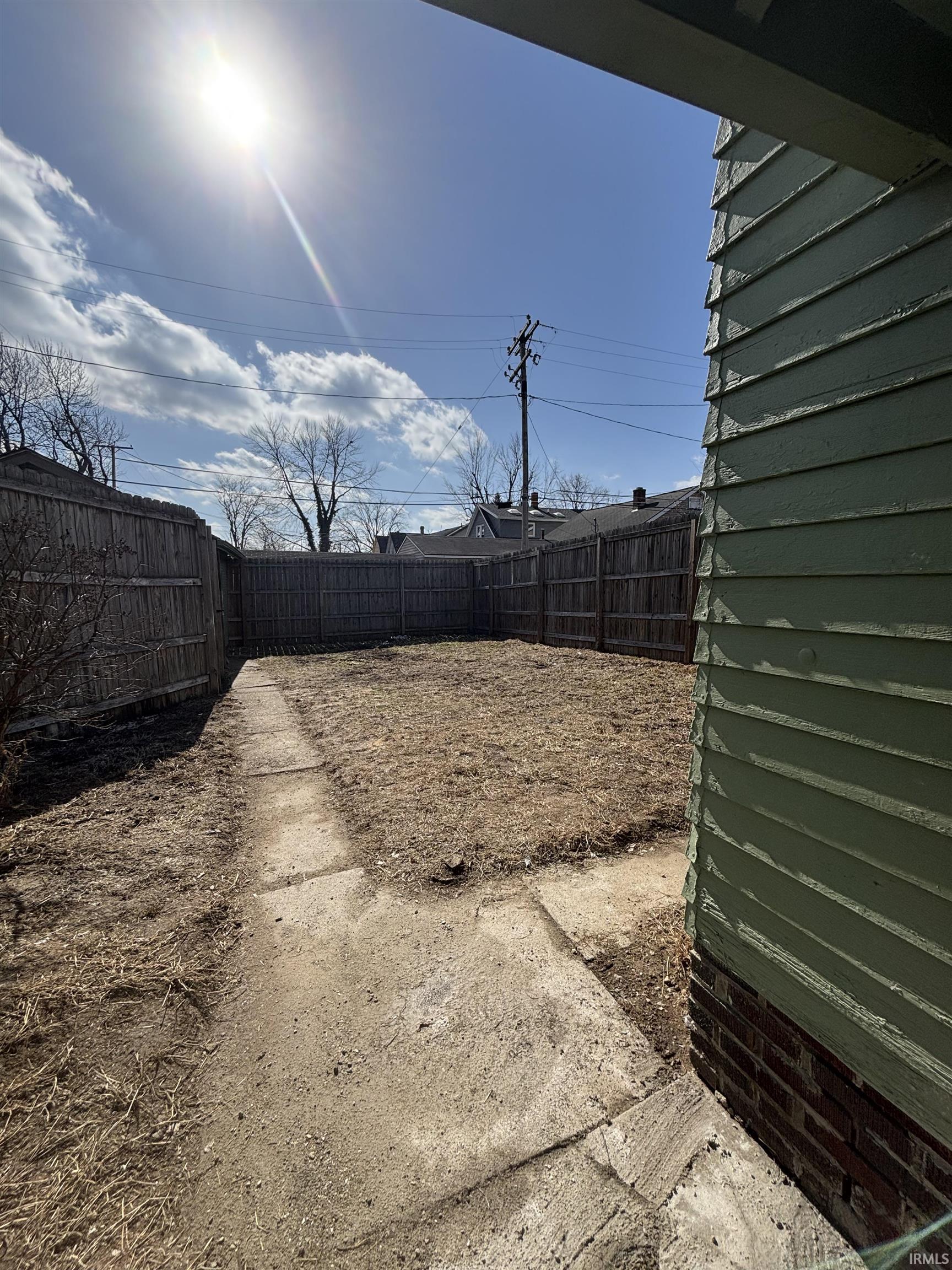 View of fenced backyard