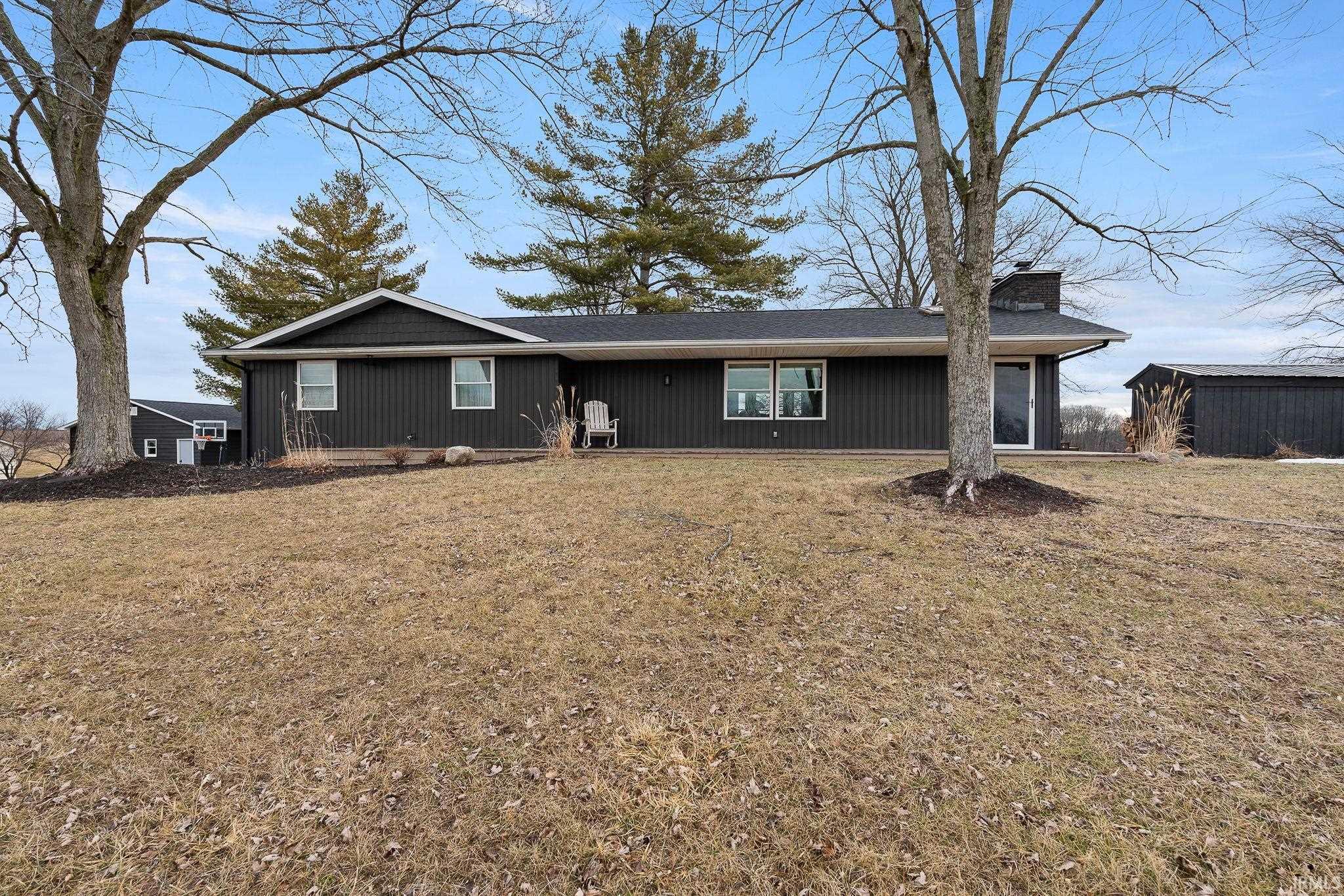 Ranch-style house with a front lawn and a chimney