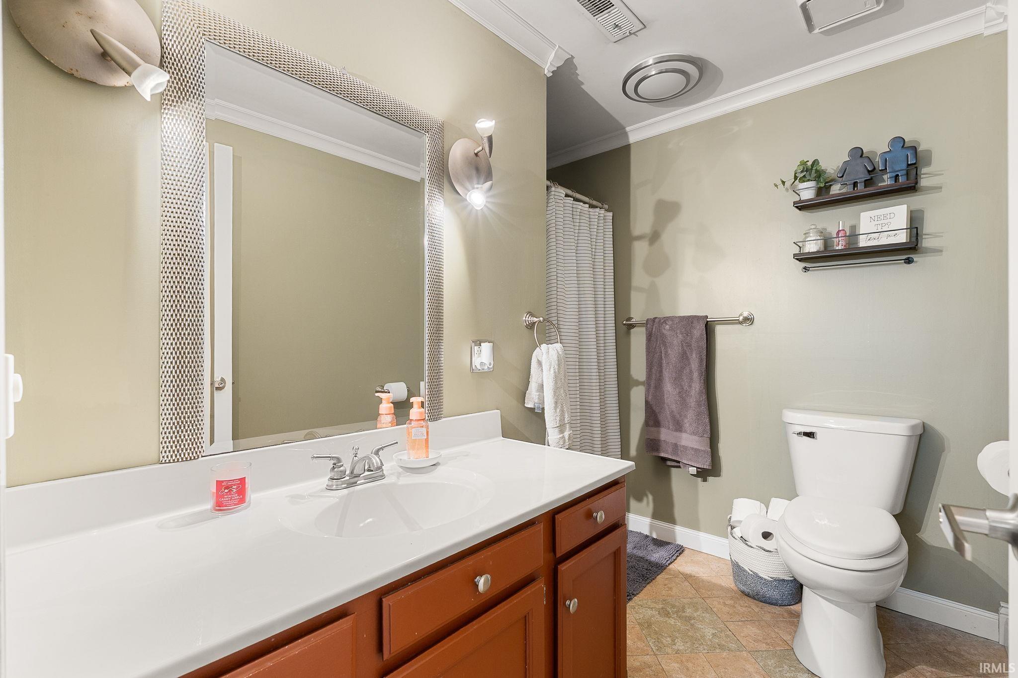 Full bathroom with a shower with shower curtain, vanity, and crown molding