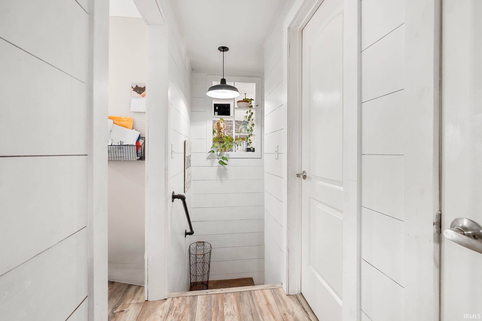 Hallway with light wood-style flooring
