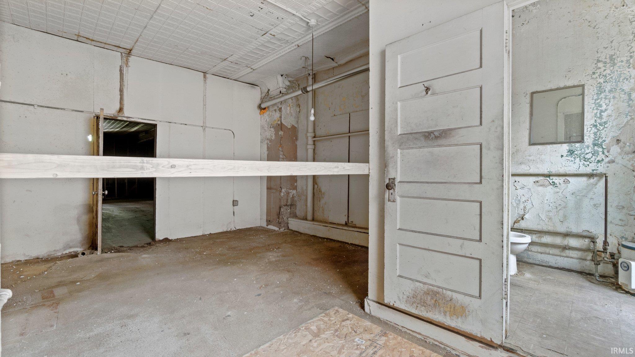 Misc room with unfinished concrete flooring