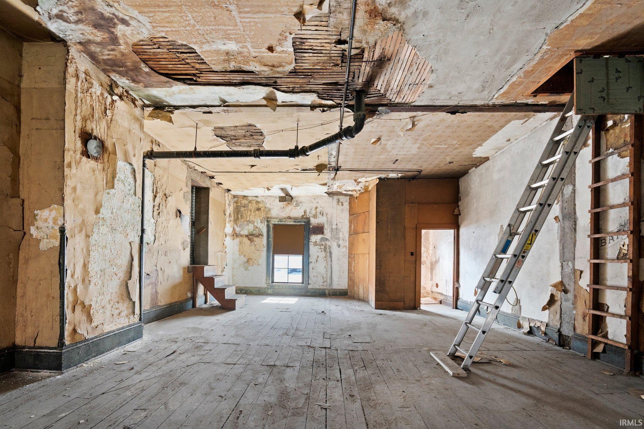 Miscellaneous room with stairs and hardwood / wood-style flooring