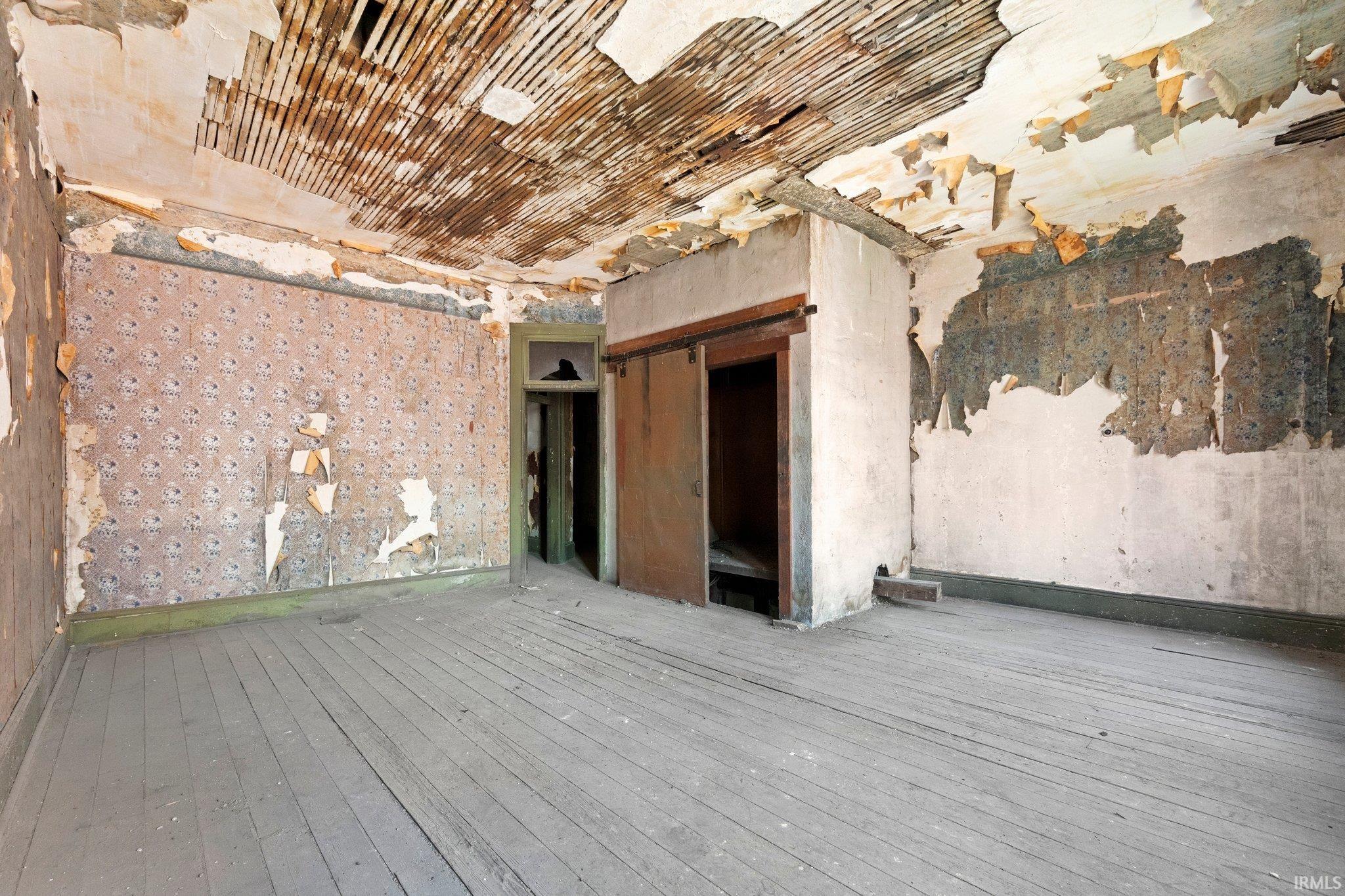 Empty room with hardwood / wood-style floors and baseboards