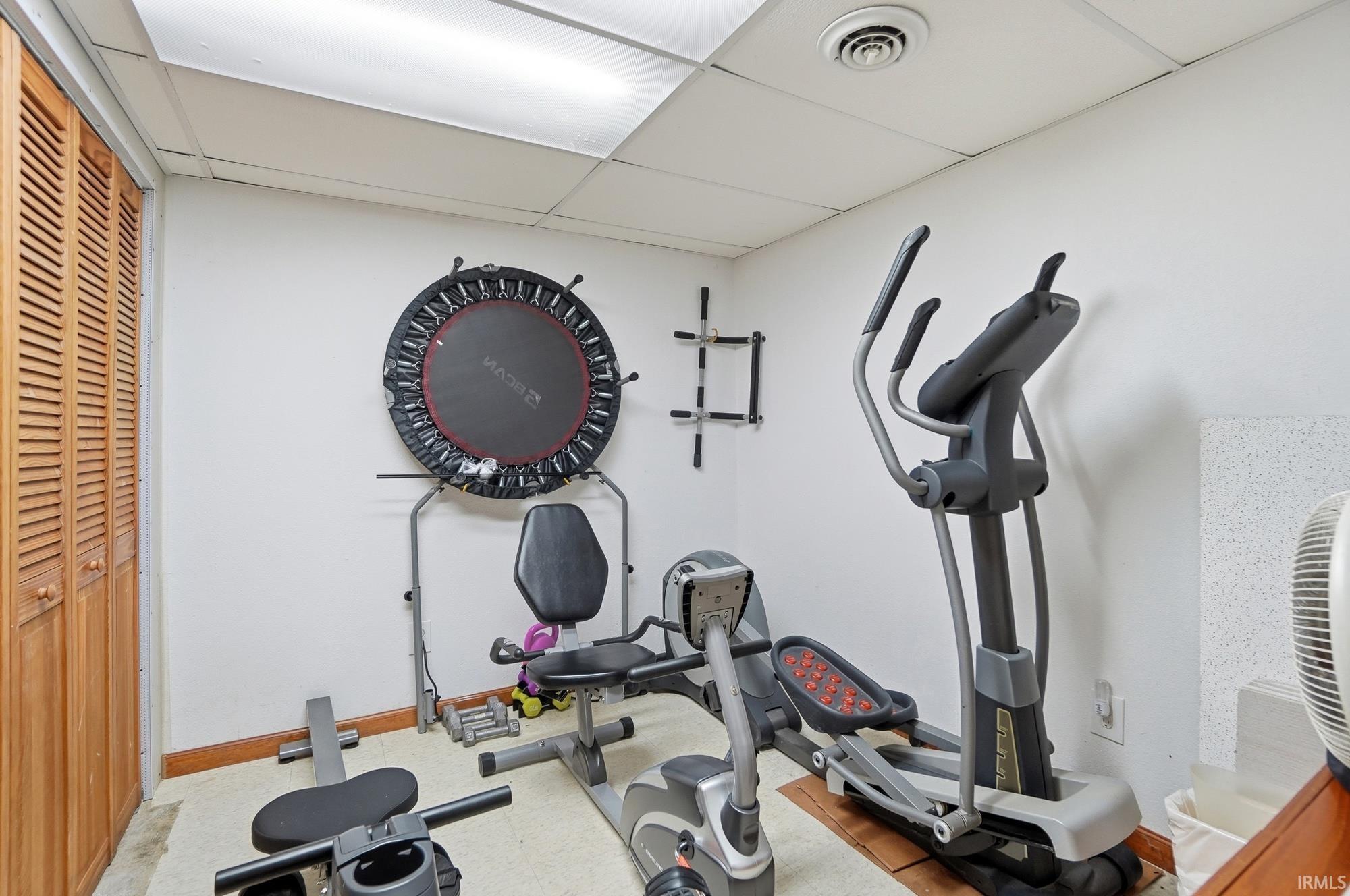 Exercise room featuring a drop ceiling