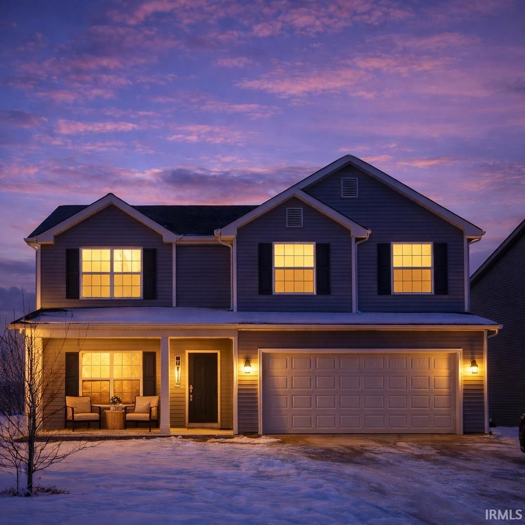 Traditional-style home with a garage, outdoor seating, a porch, and driveway