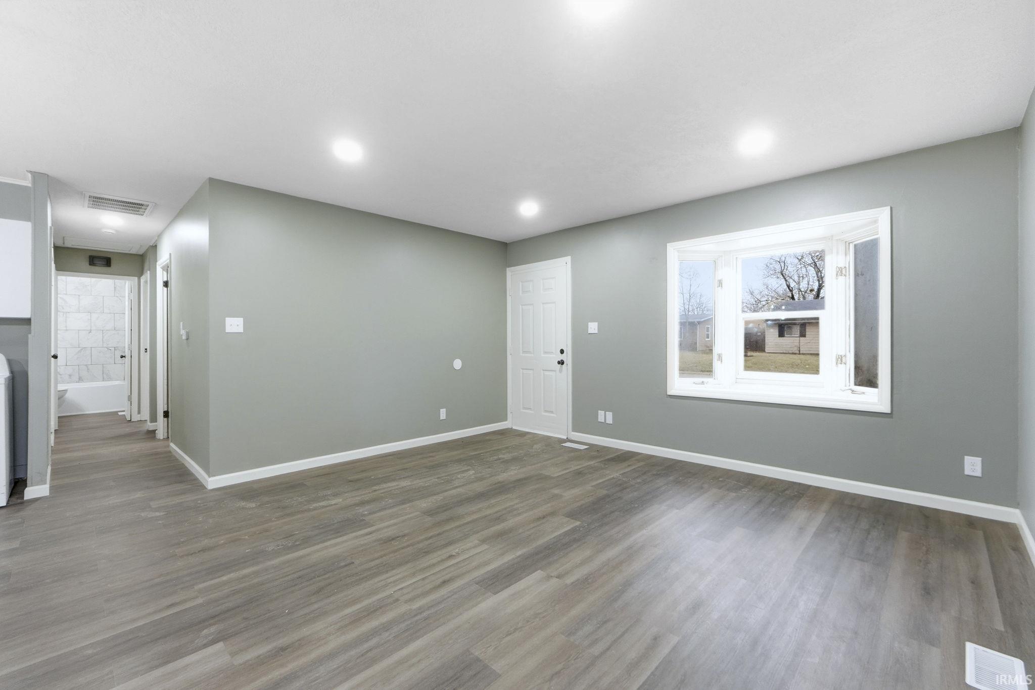 Foyer featuring wood finished floors and recessed lighting
