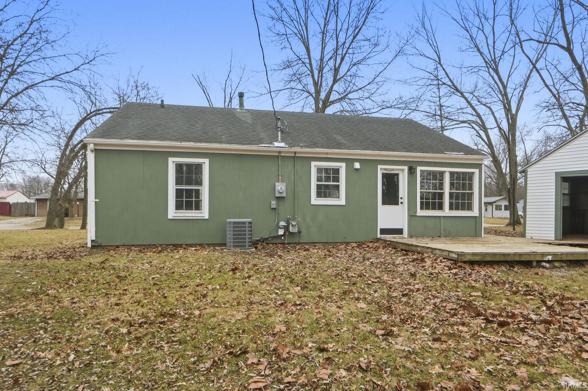Back of house featuring roof with shingles
