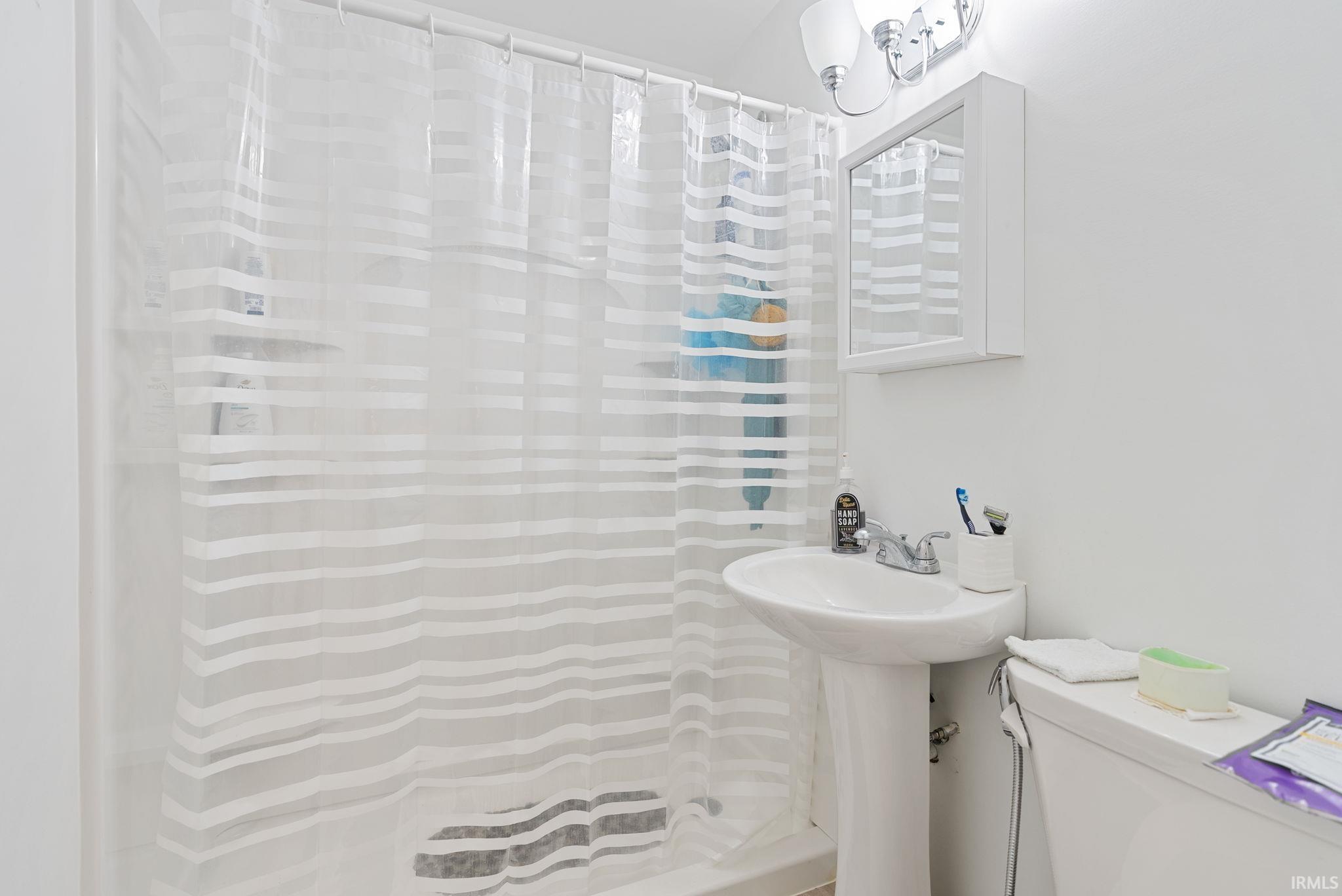 Full bath with curtained shower