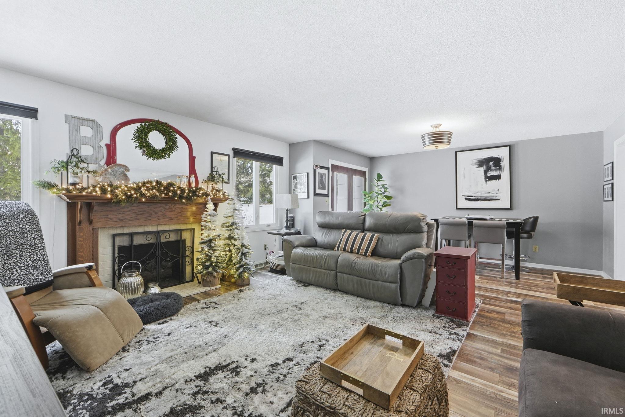 Living area featuring wood finished floors and a fireplace