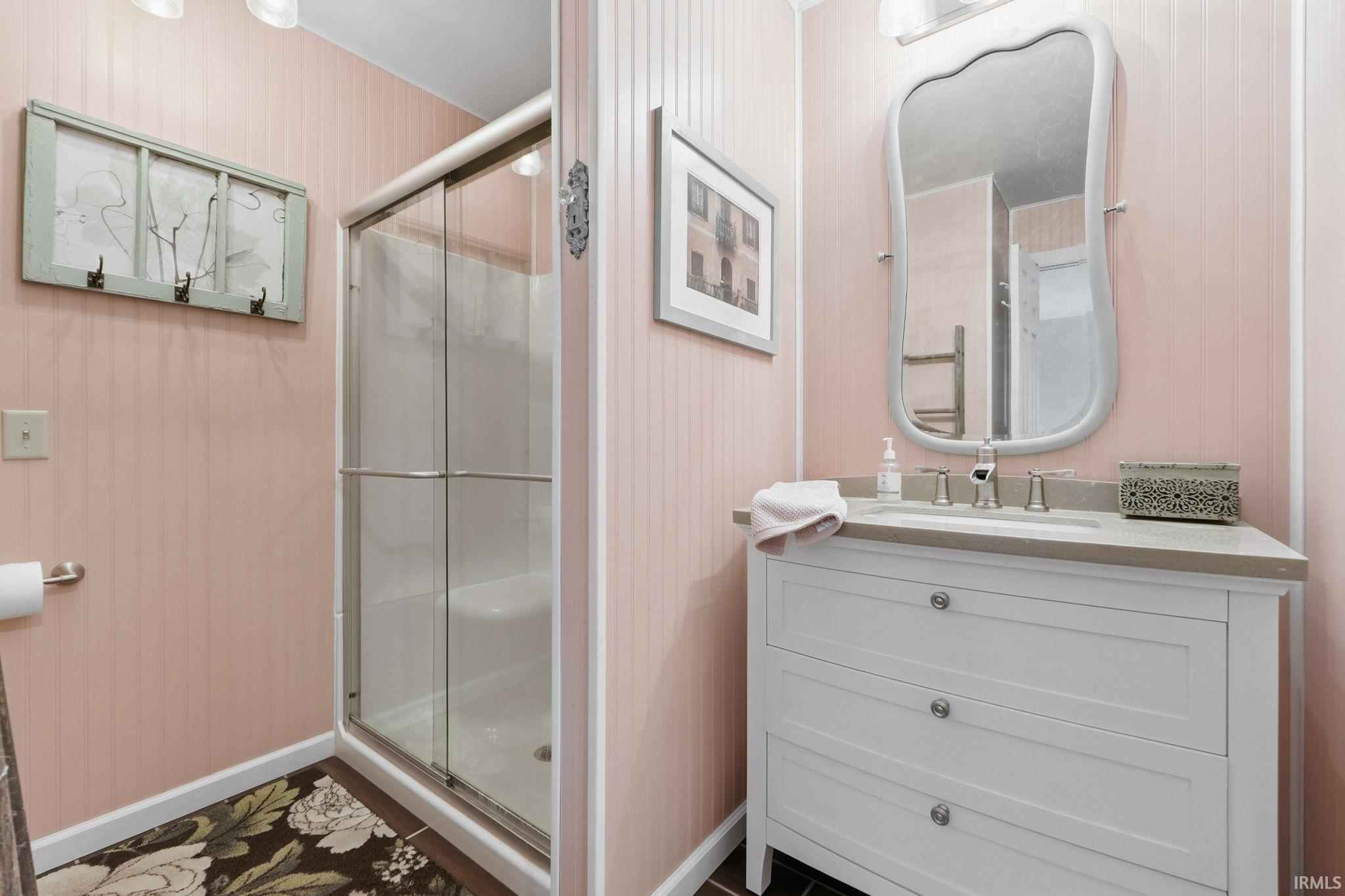 Full bathroom with vanity and a stall shower