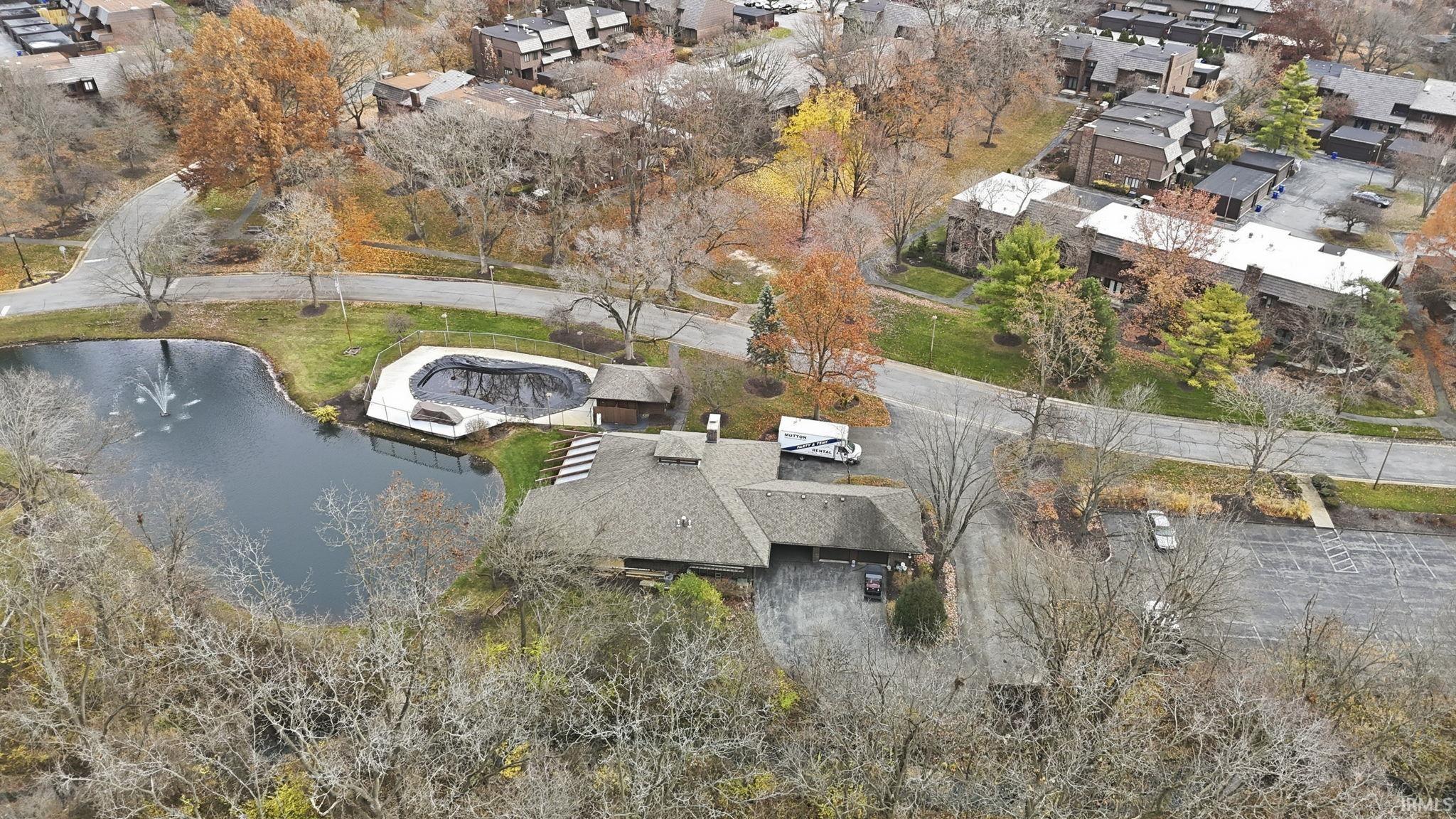 Aerial perspective of suburban area featuring a large body of water