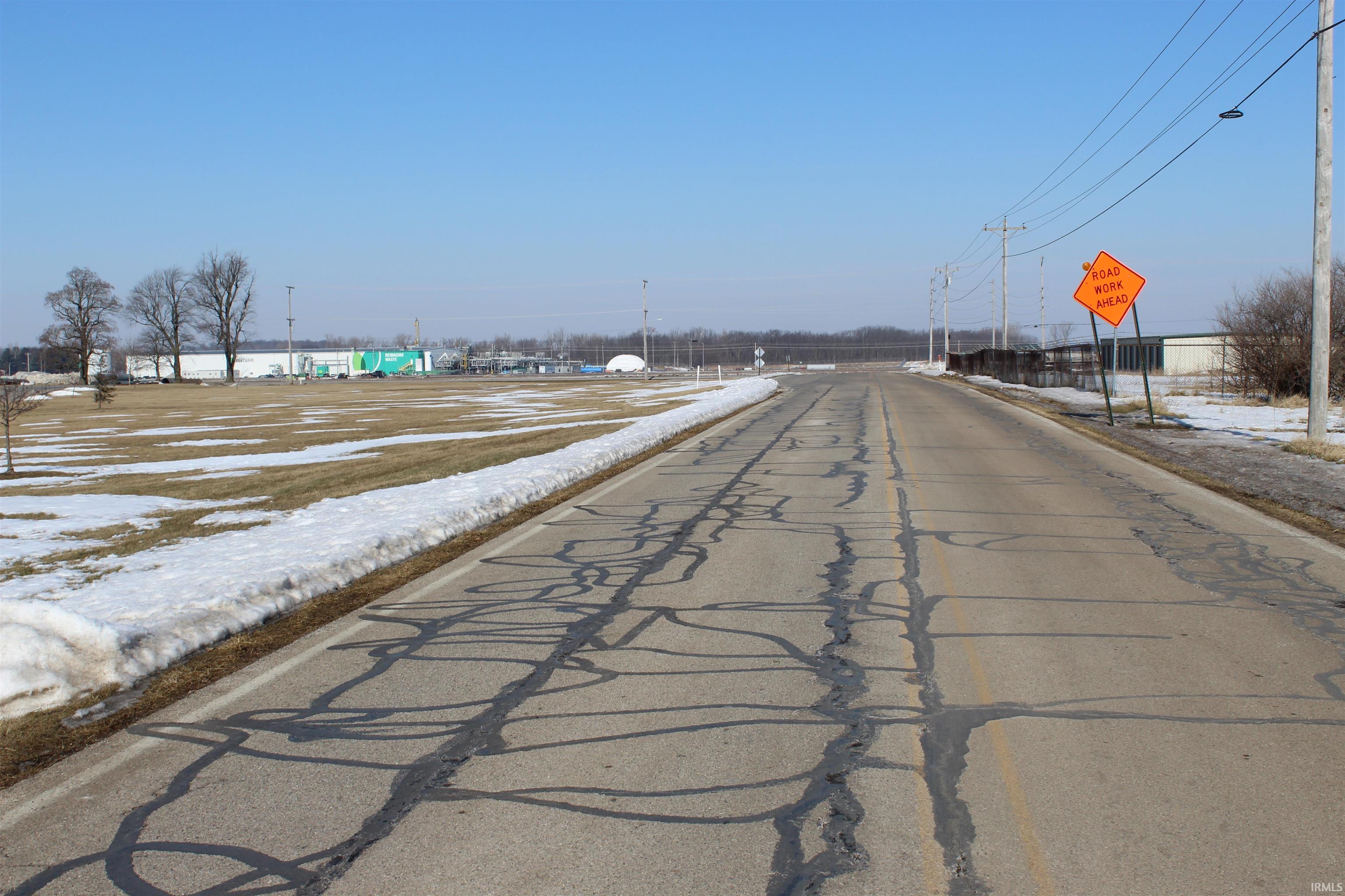 View of asphalt road featuring traffic signs