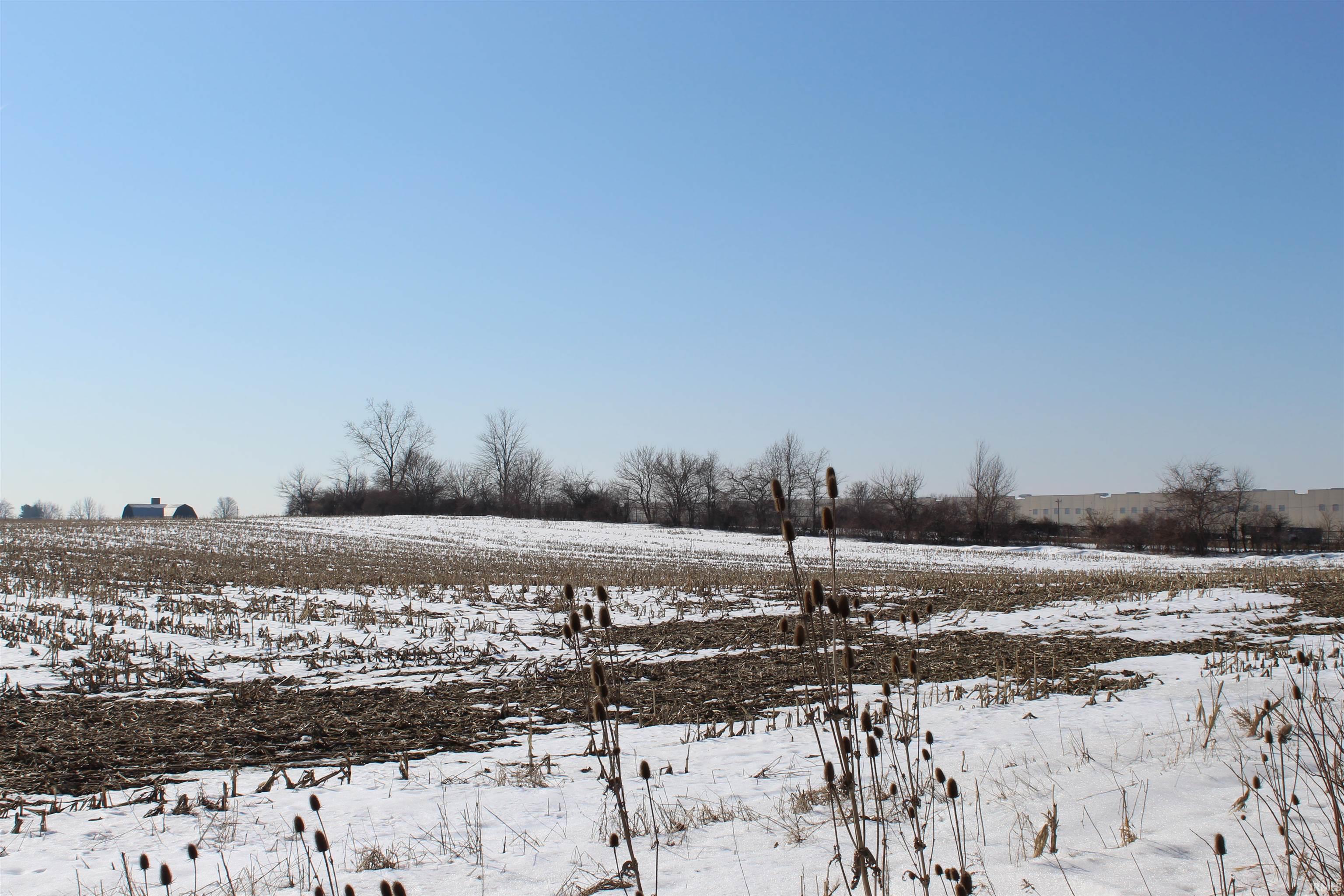 Snowy yard with a view of countryside