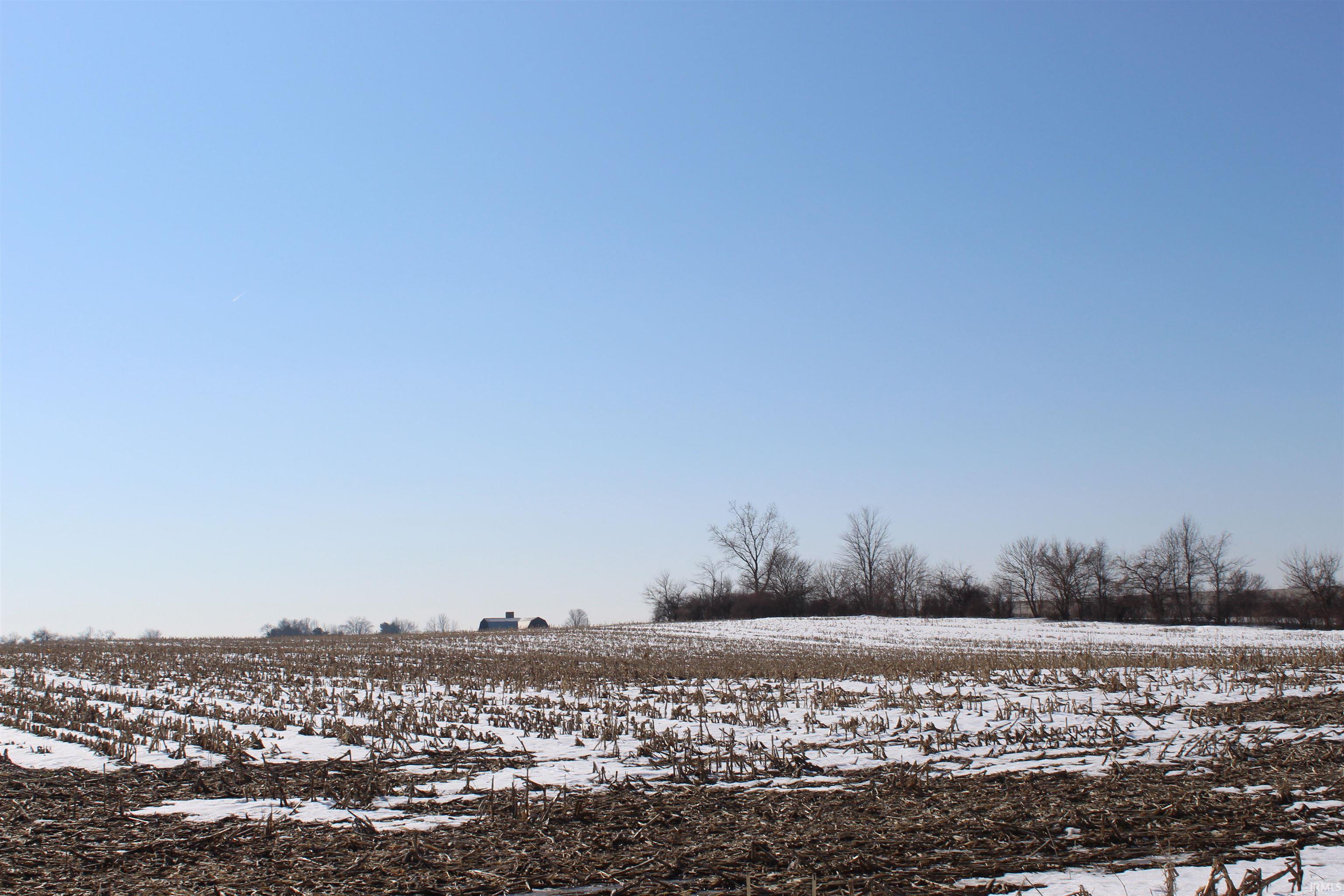 Snowy yard featuring a rural view