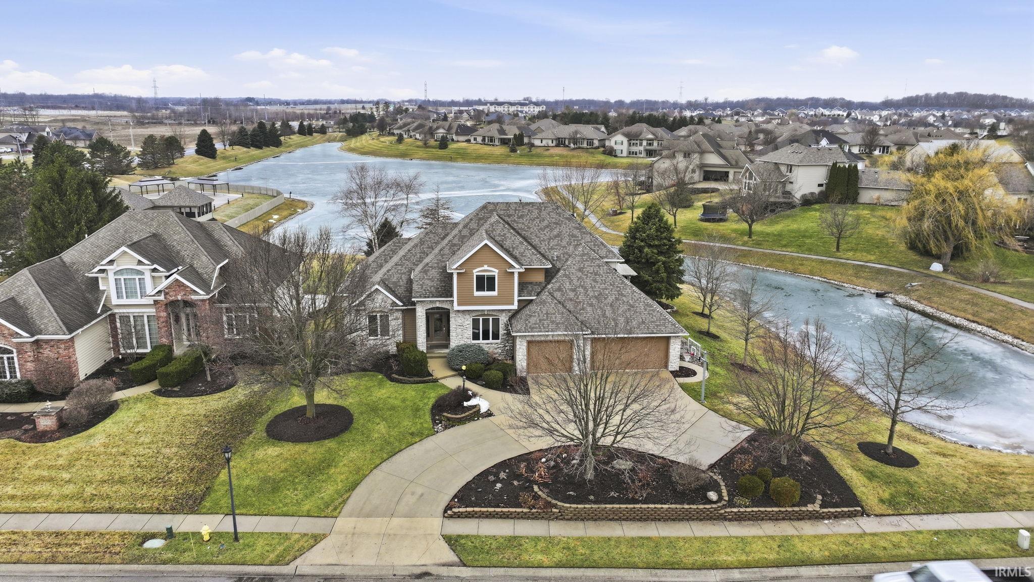 Aerial view of residential area featuring a large body of water