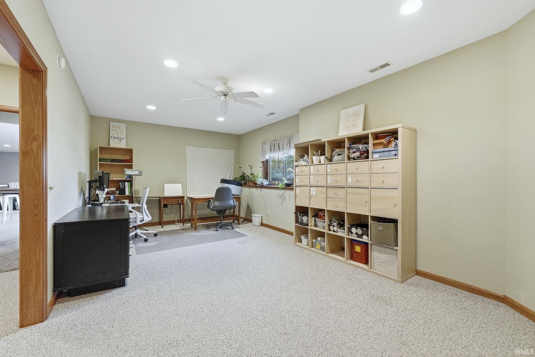 Office space featuring light carpet, ceiling fan, and recessed lighting