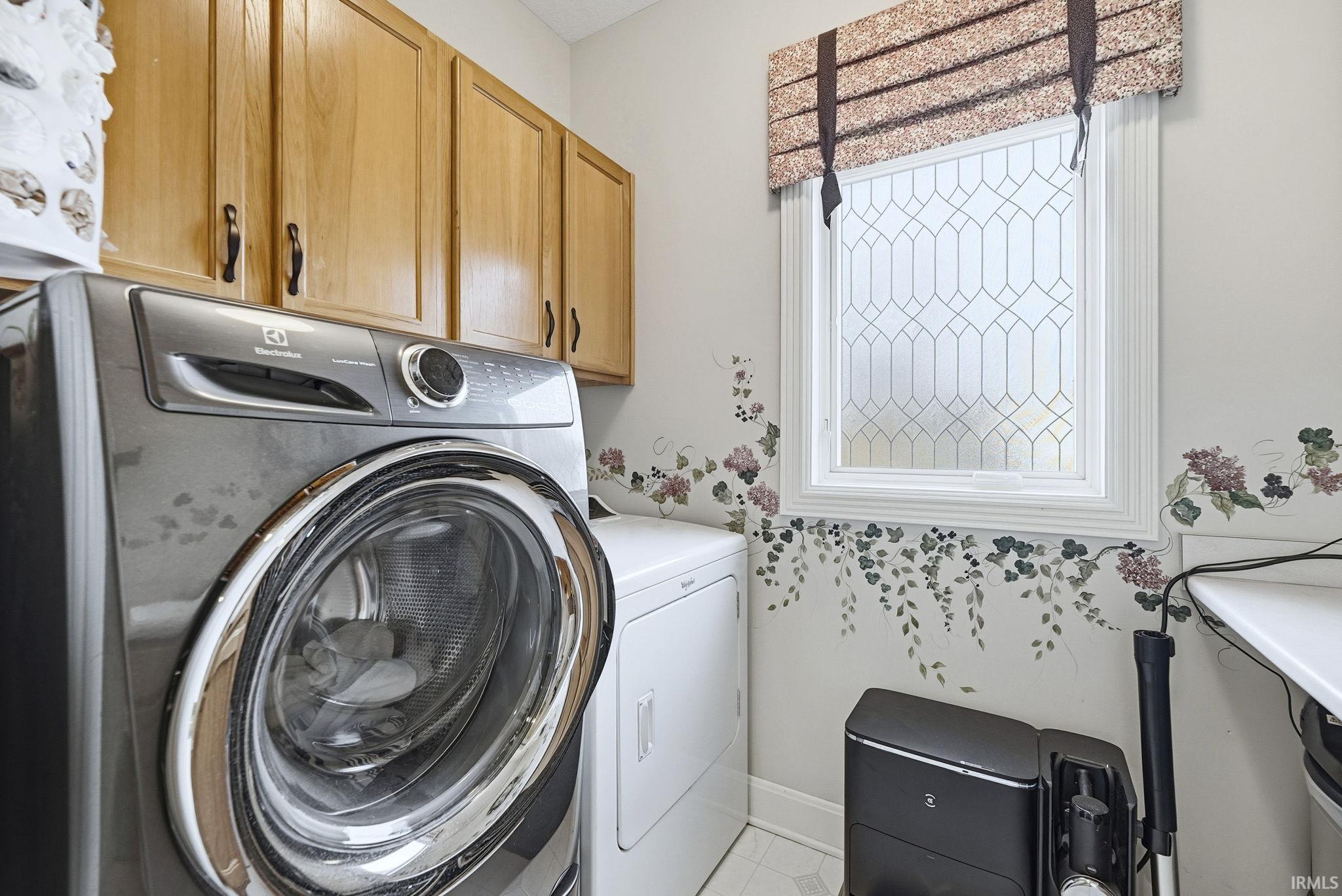 Laundry room featuring cabinet space and separate washer and dryer