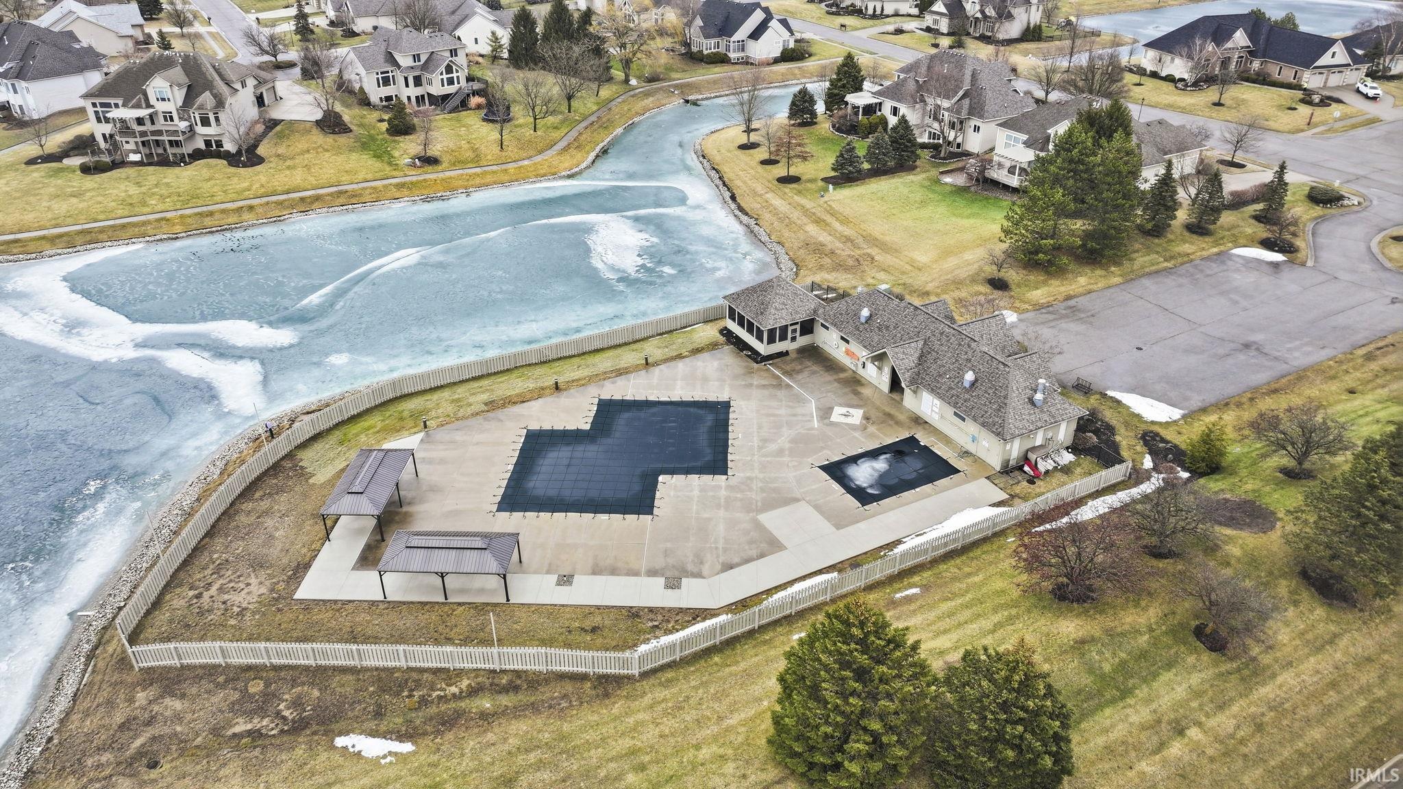 Aerial perspective of suburban area featuring a pool area