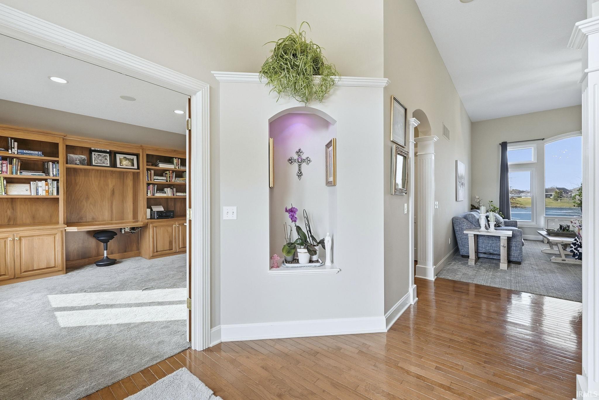 Hall with an office area and light wood-style floors
