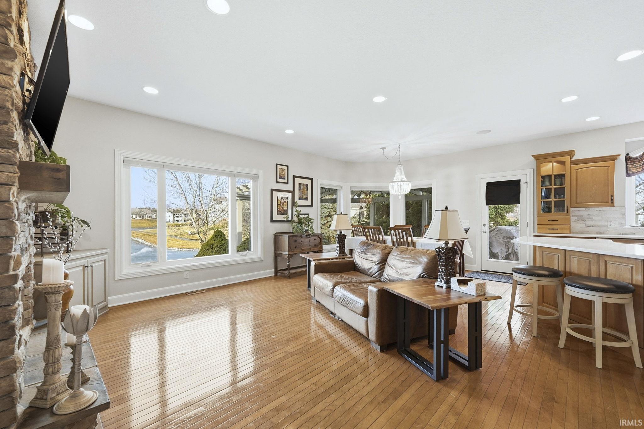 Living area featuring dark wood finished floors and recessed lighting