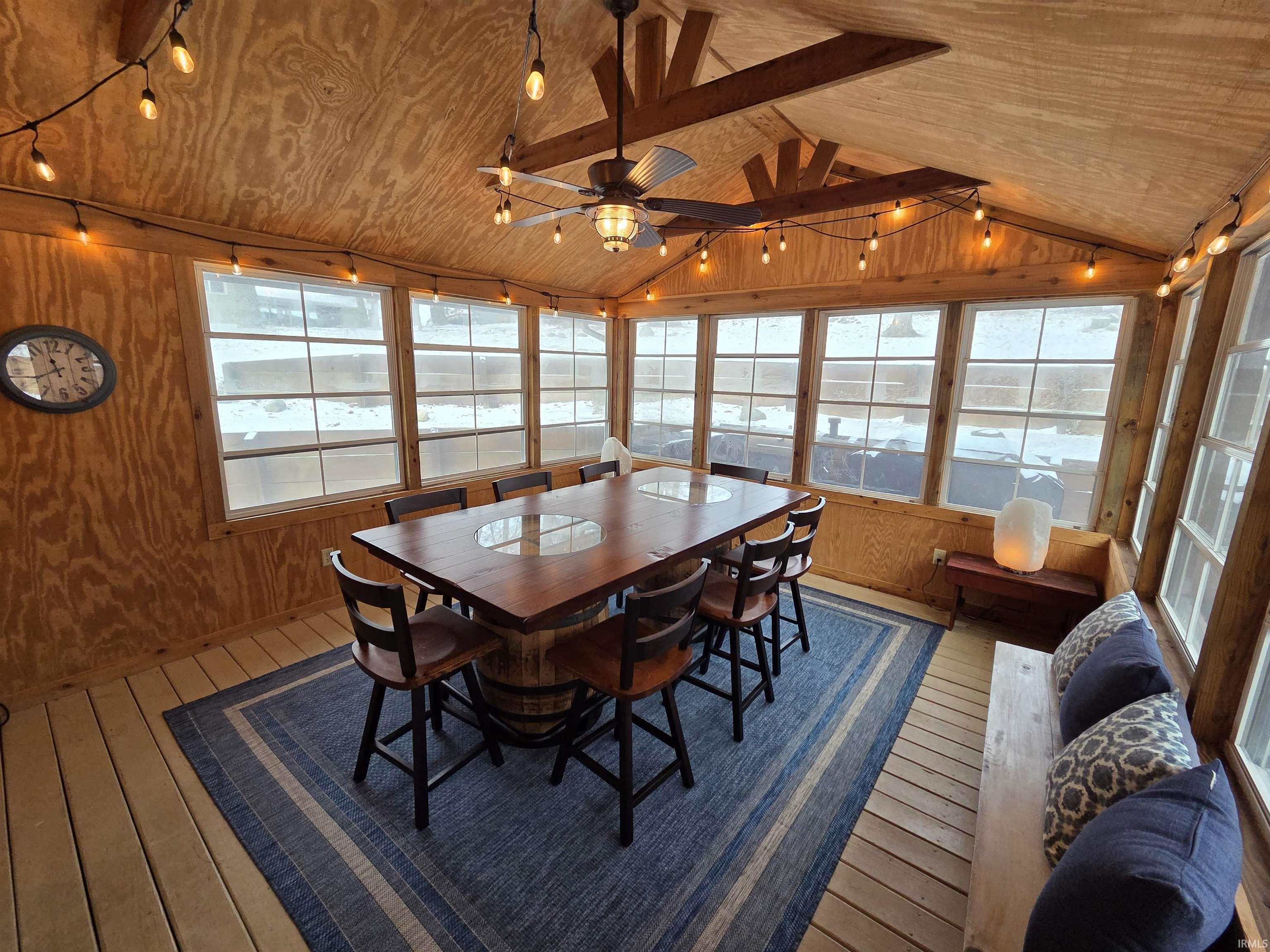 Sunroom / solarium featuring wood-type flooring, wood walls, and wood ceiling