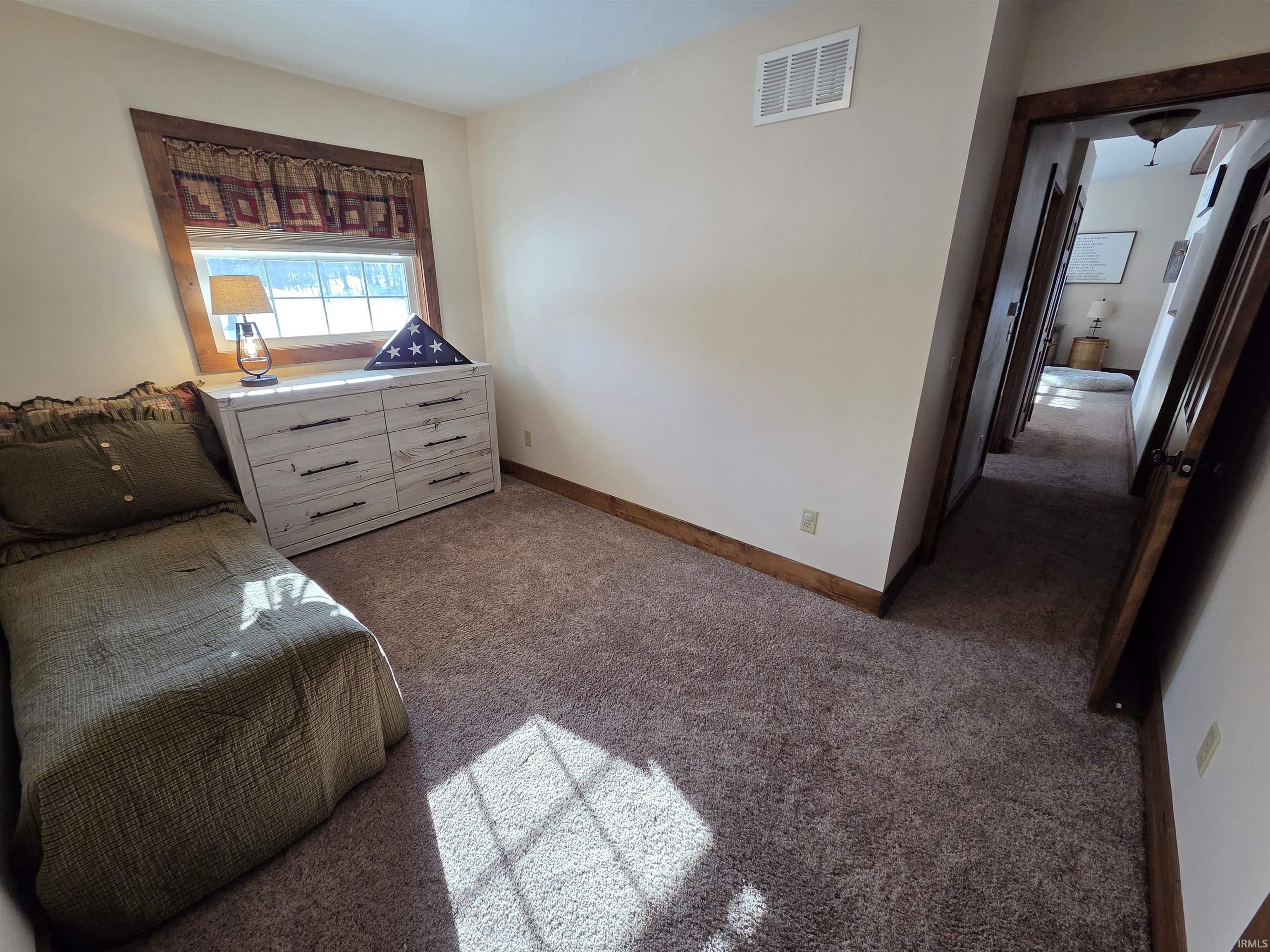 Carpeted bedroom with baseboards