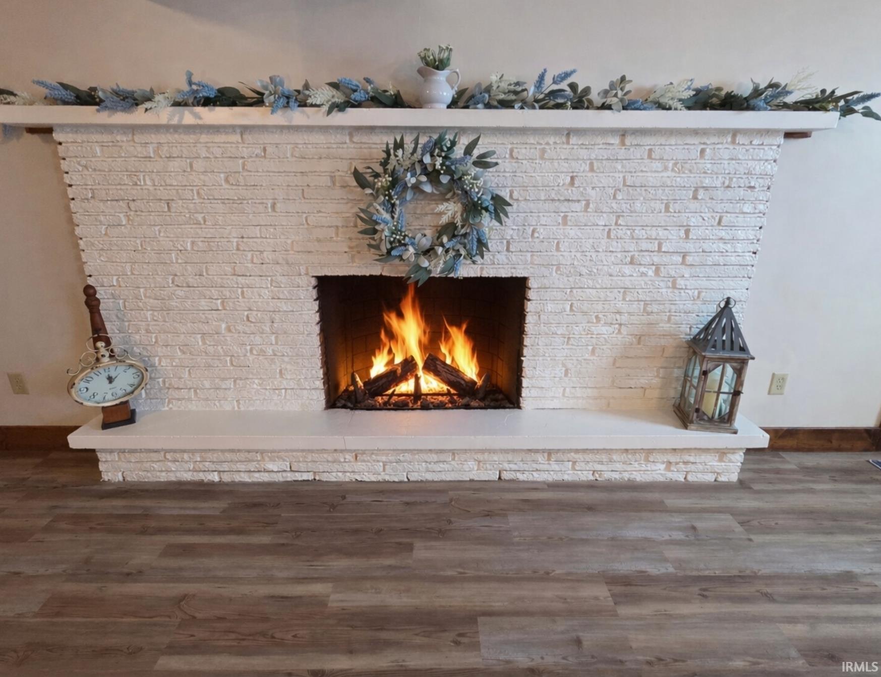 Detailed view of a brick fireplace and wood finished floors