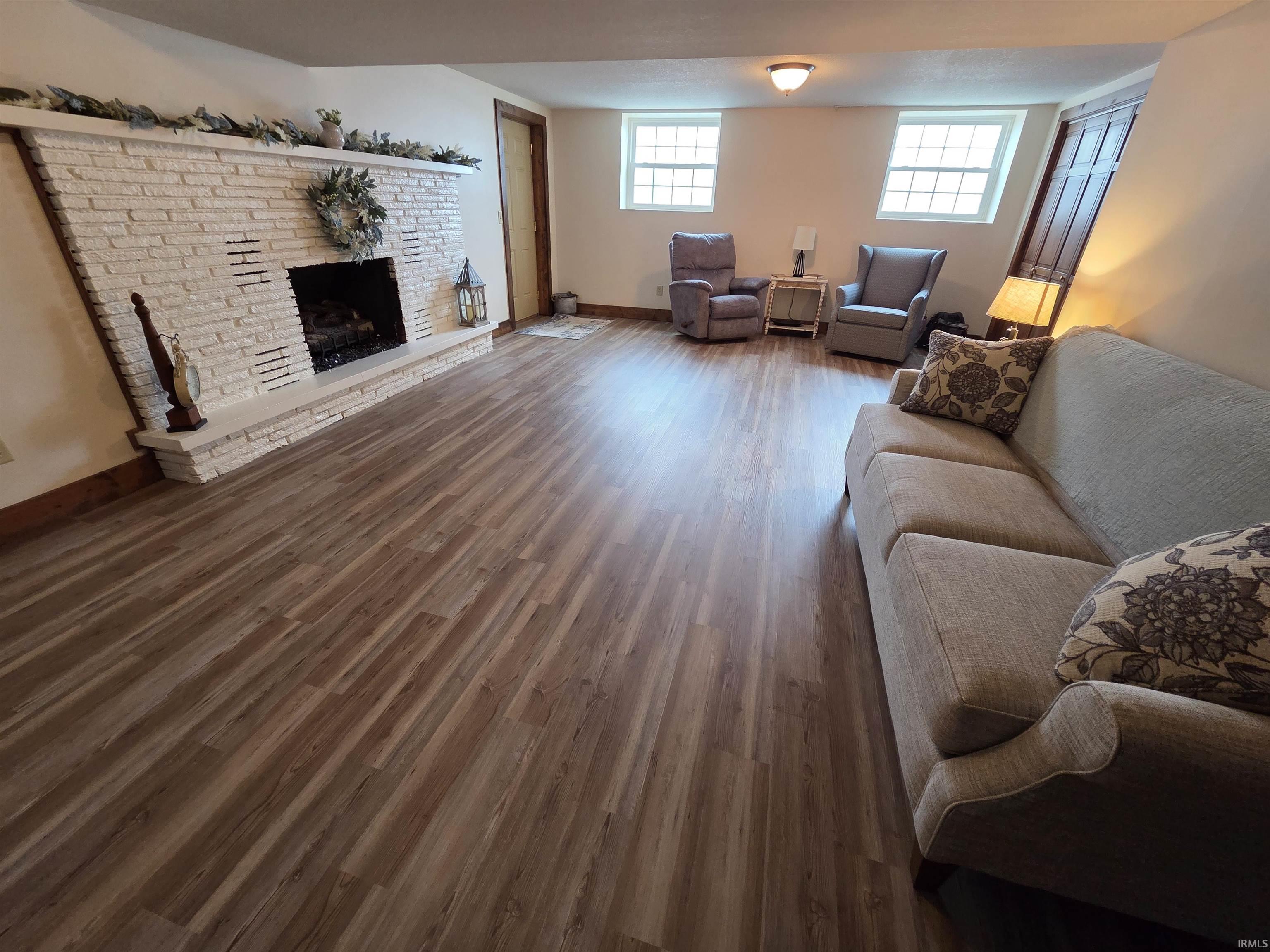 Living room featuring dark wood finished floors and a fireplace