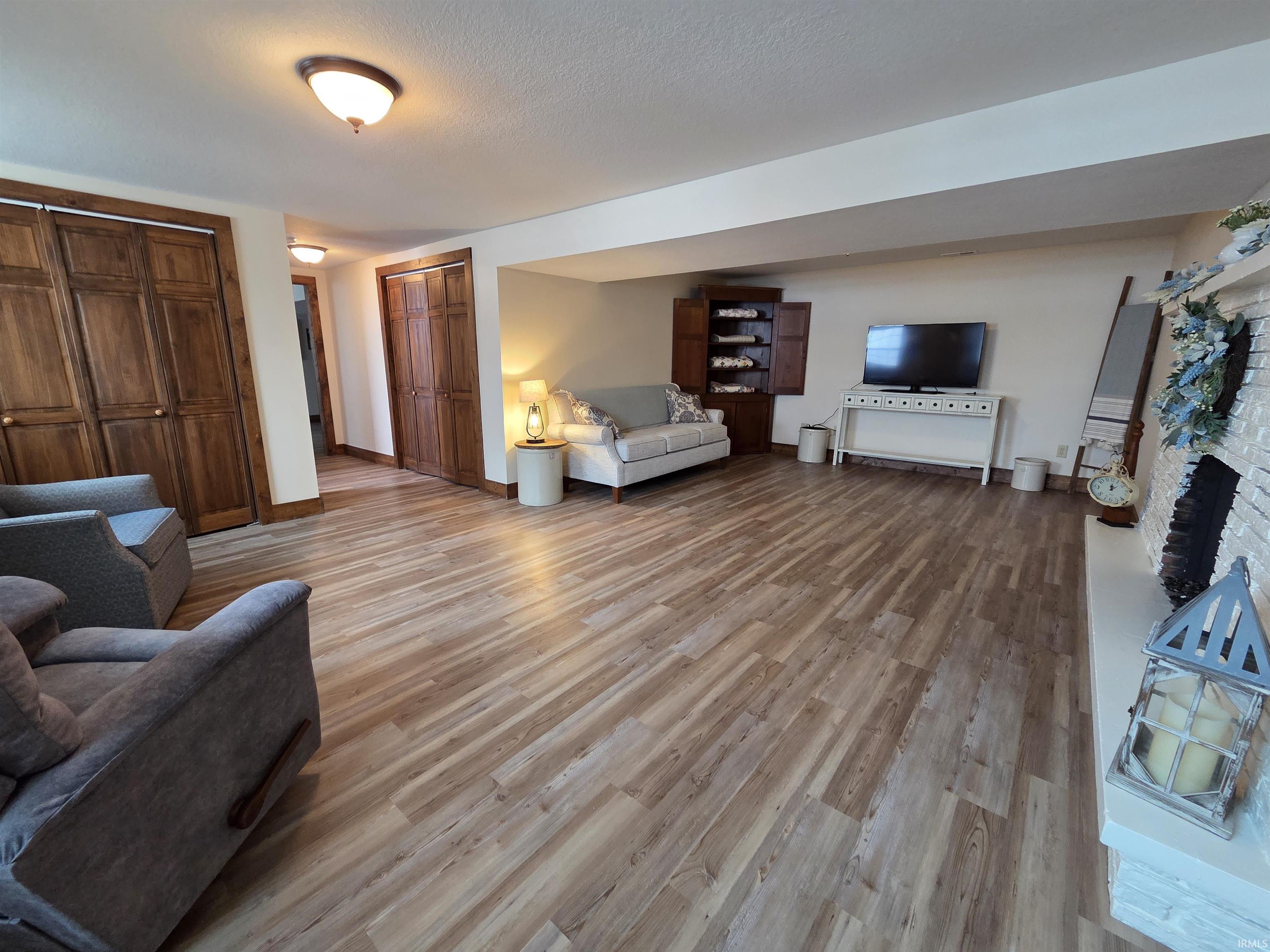 Living area with light wood finished floors and a fireplace