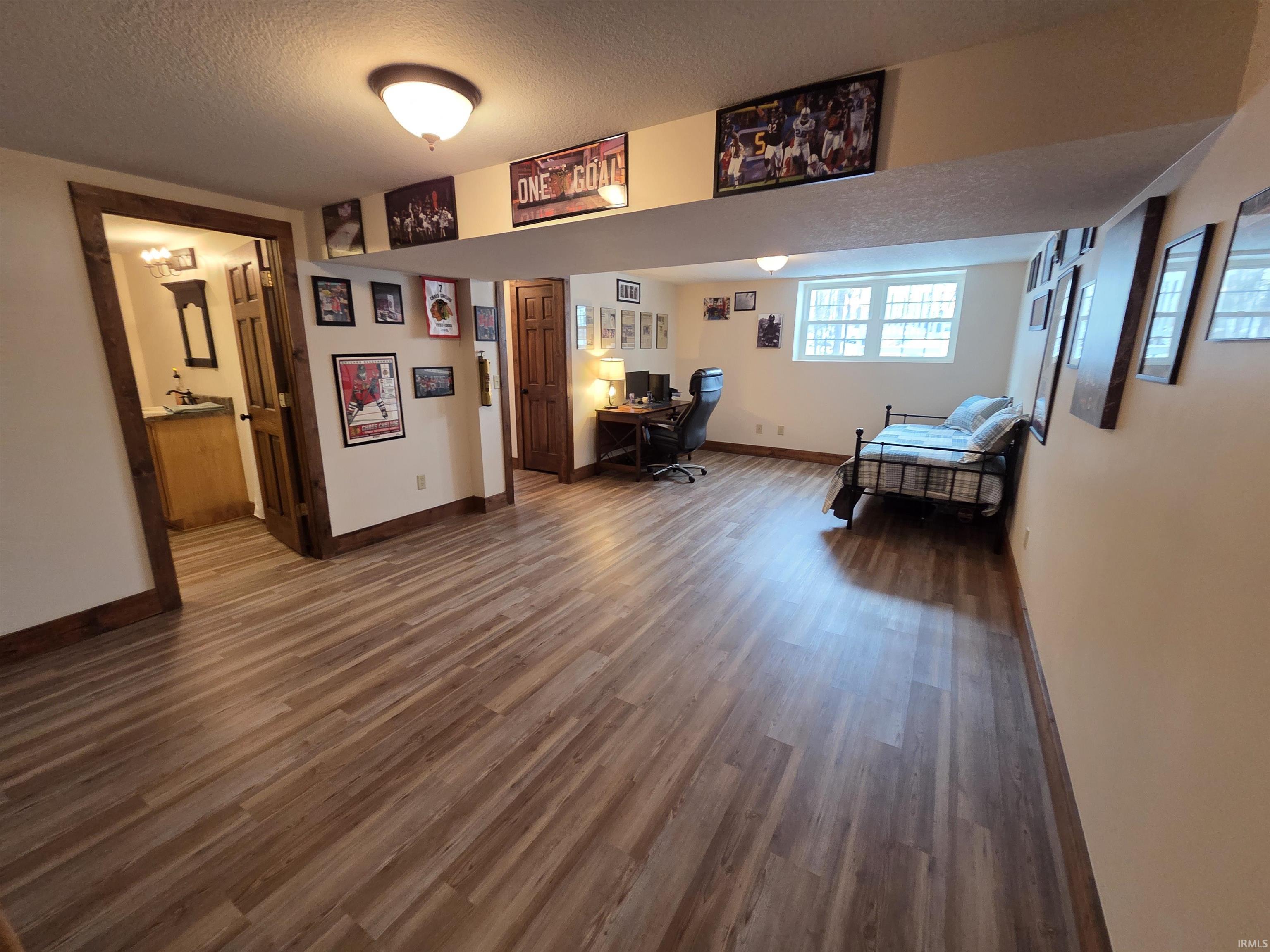 Office featuring dark wood-style flooring and a textured ceiling