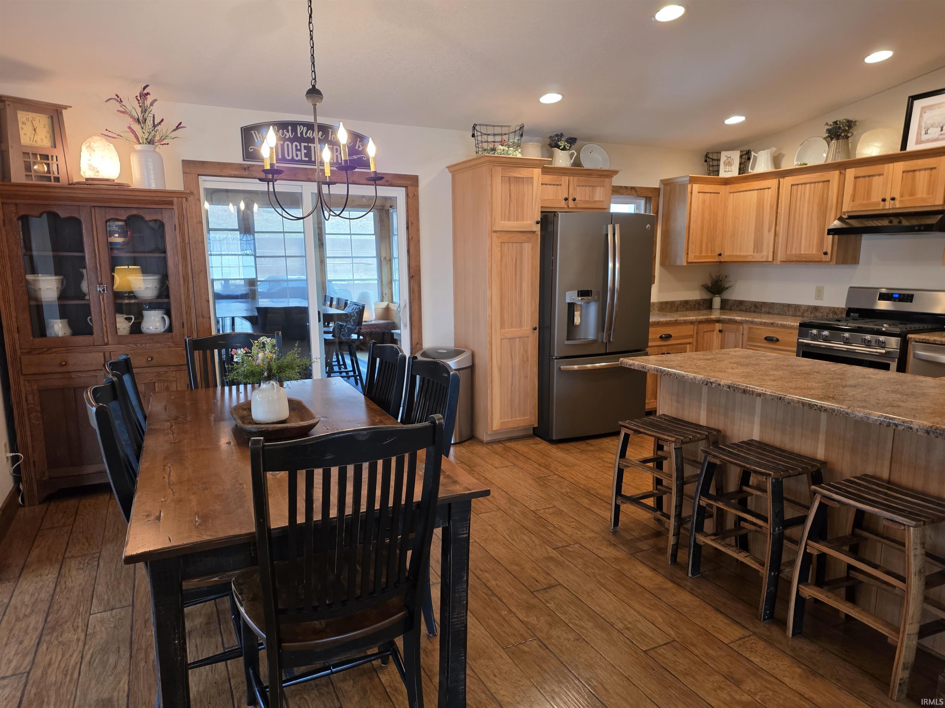 Dining room with a chandelier and dark wood-type flooring