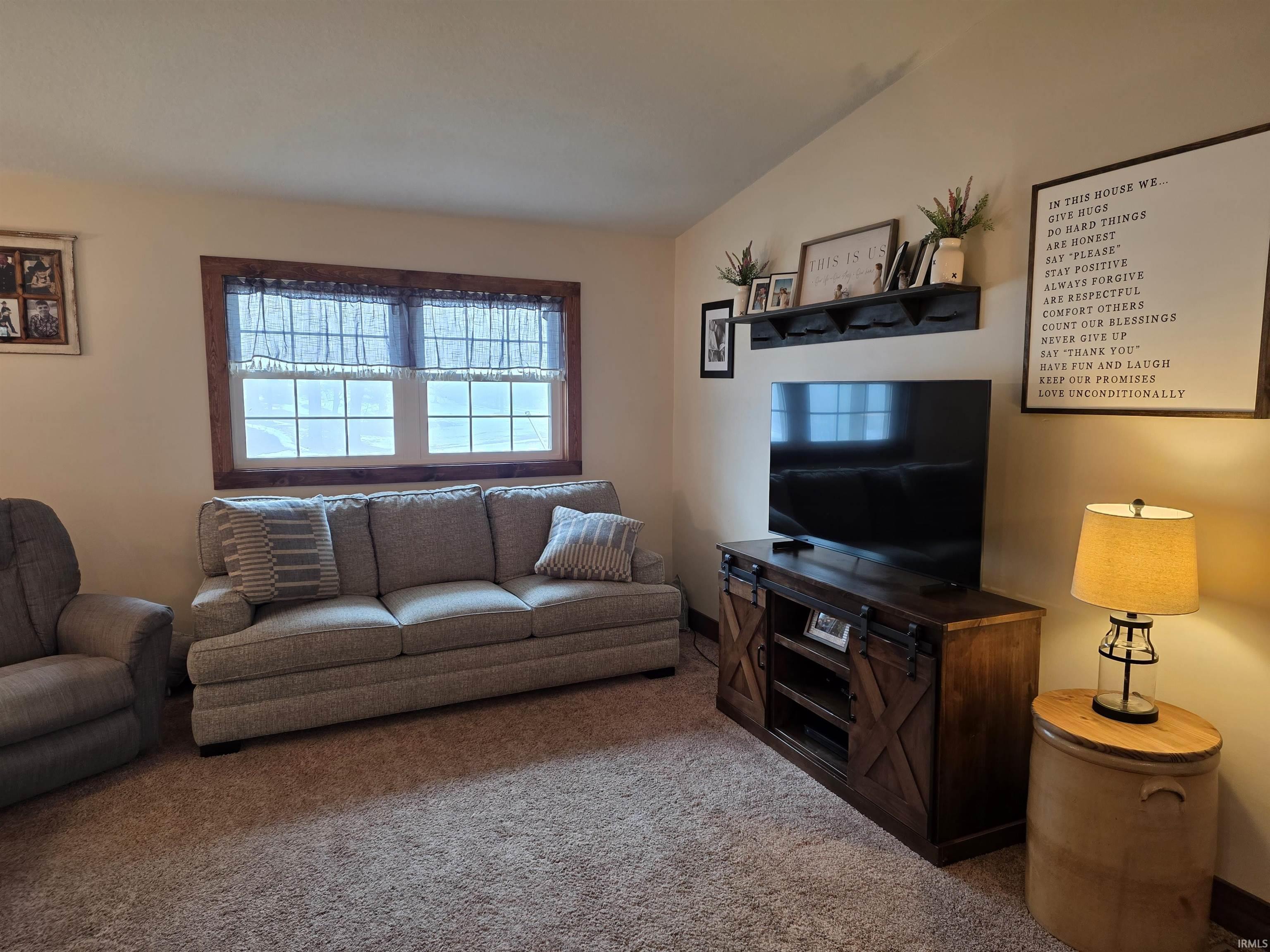 Carpeted living room featuring baseboards