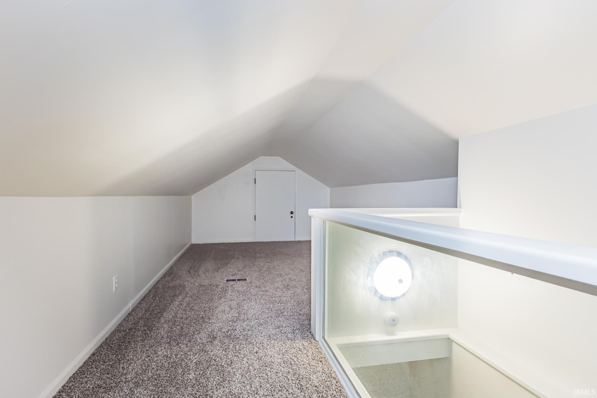Bonus room with carpet and baseboards