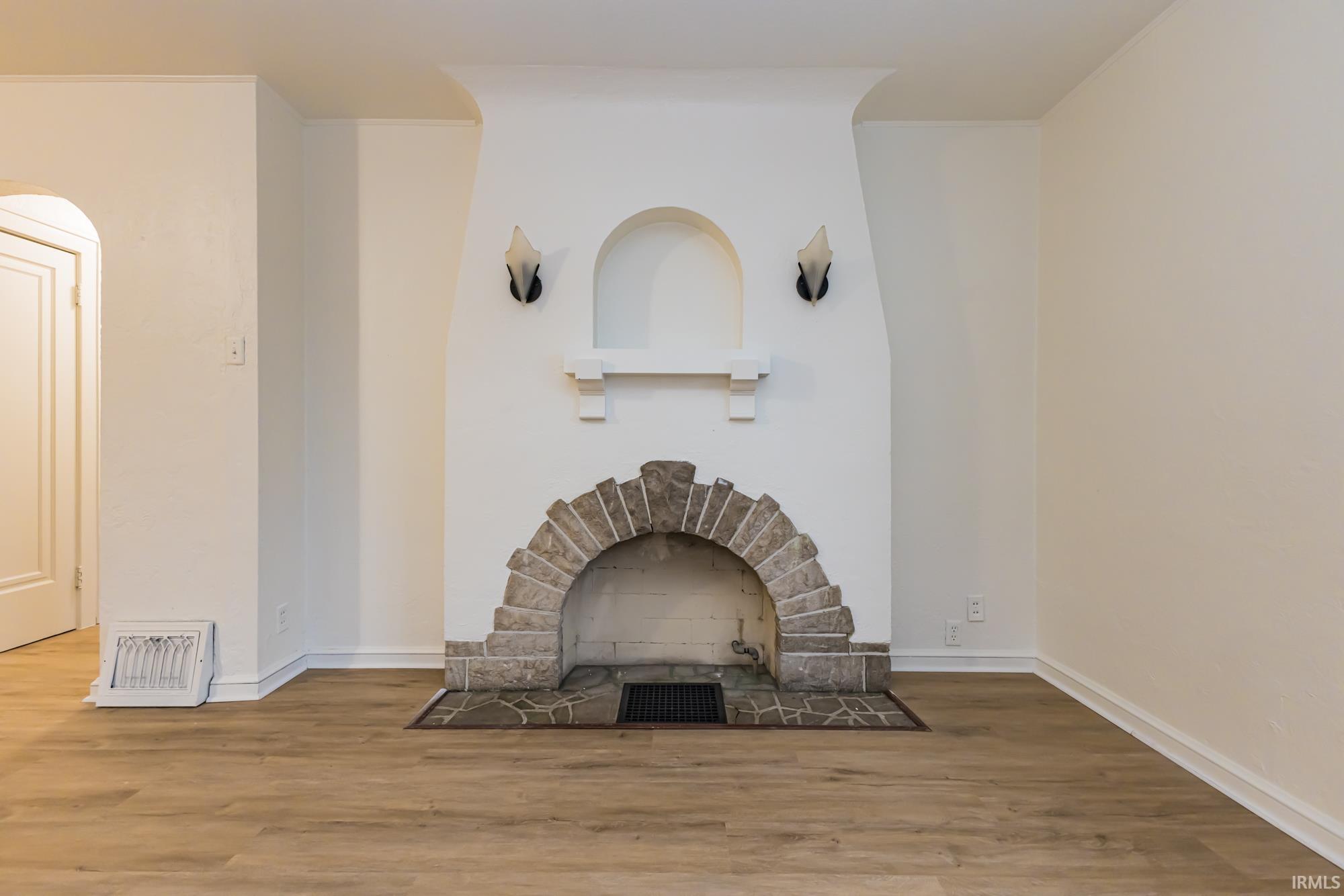 Living area featuring wood finished floors and a stone fireplace