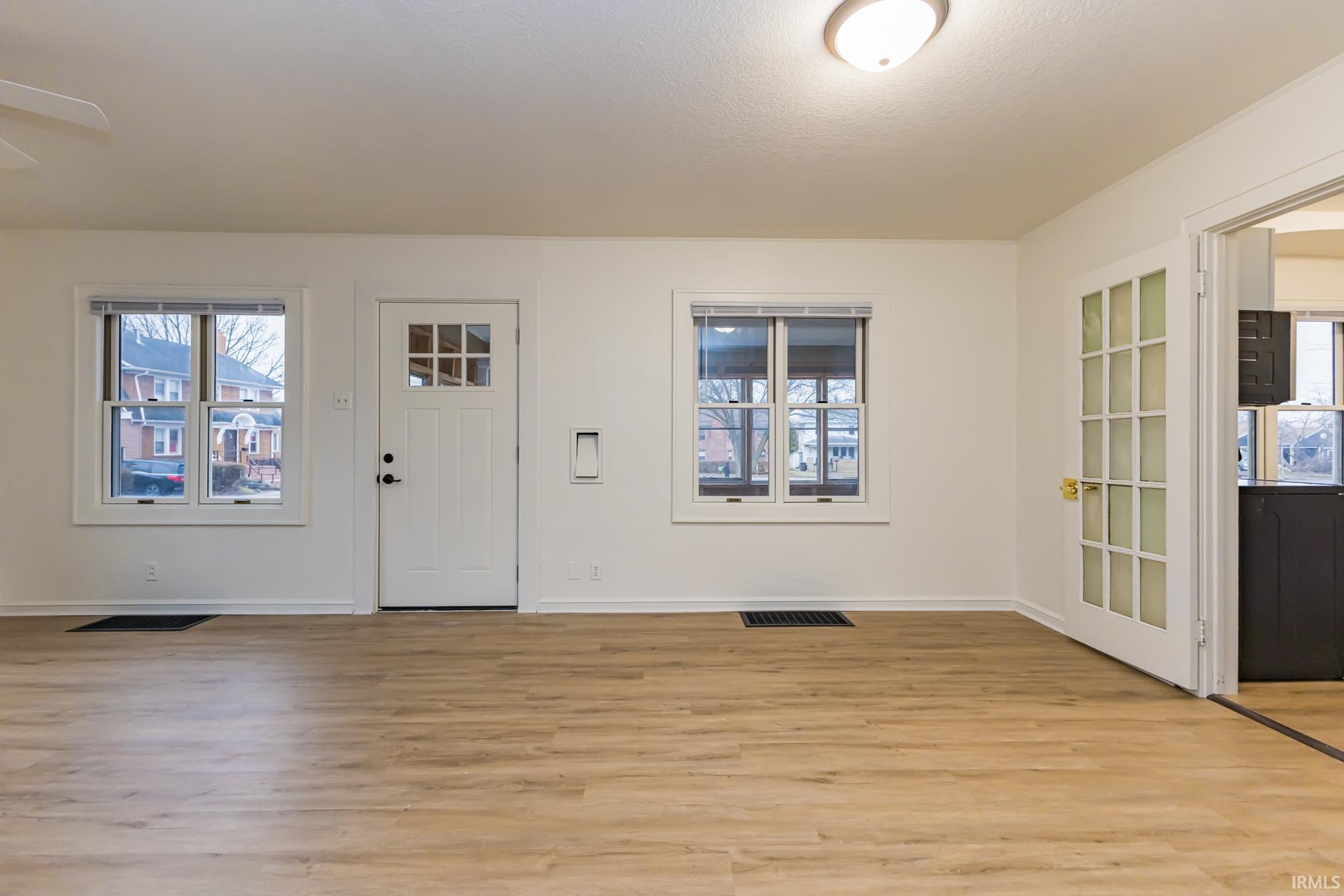 Foyer entrance featuring plenty of natural light and light wood-style floors