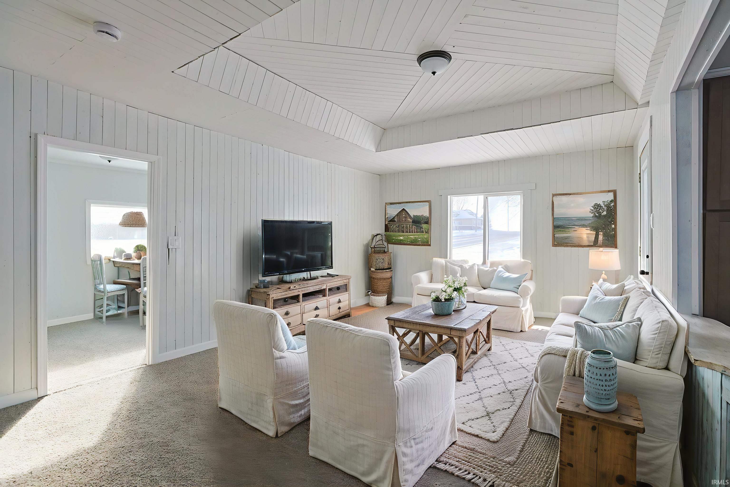 Living area with wood walls and wooden ceiling