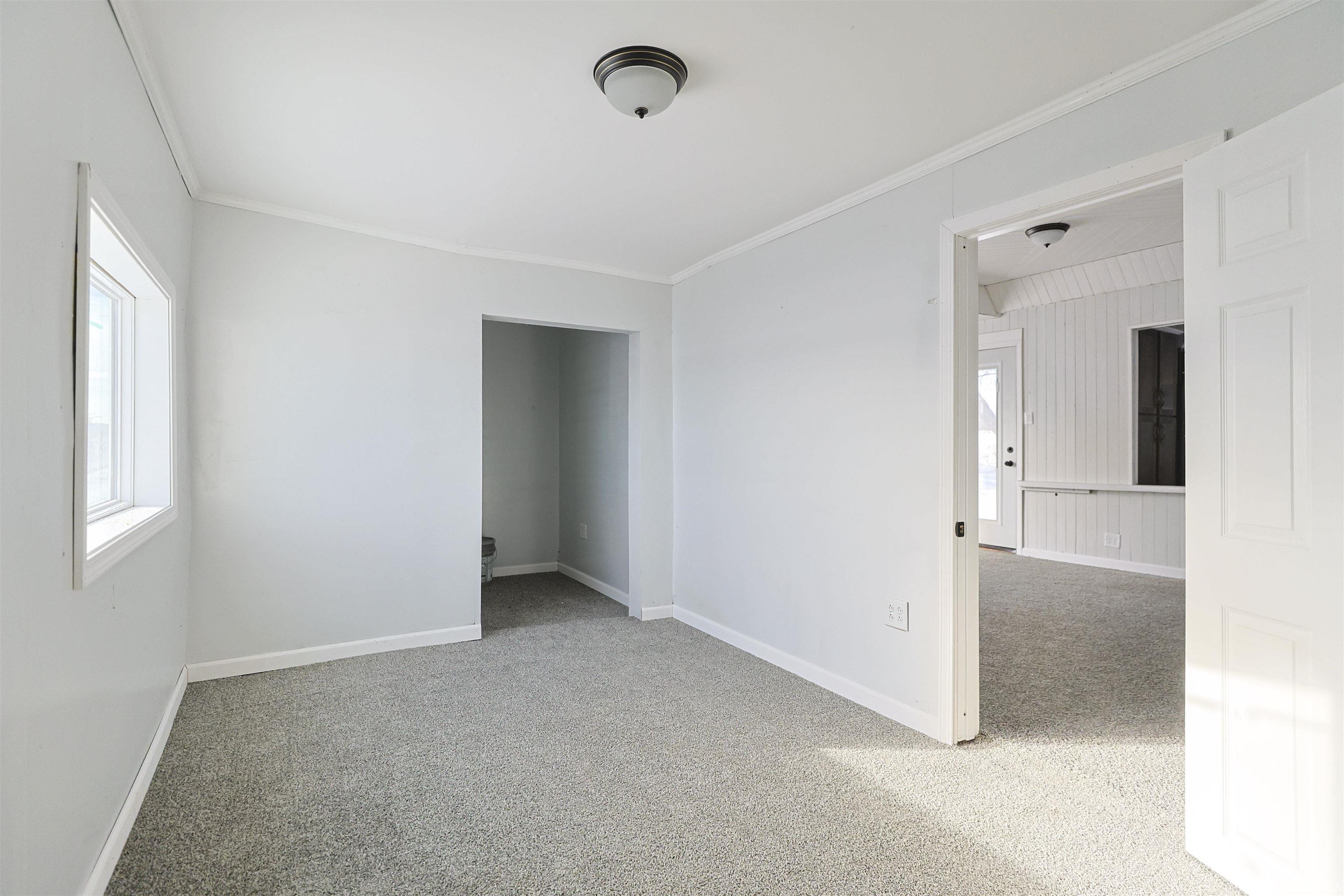 Unfurnished room with light colored carpet and ornamental molding