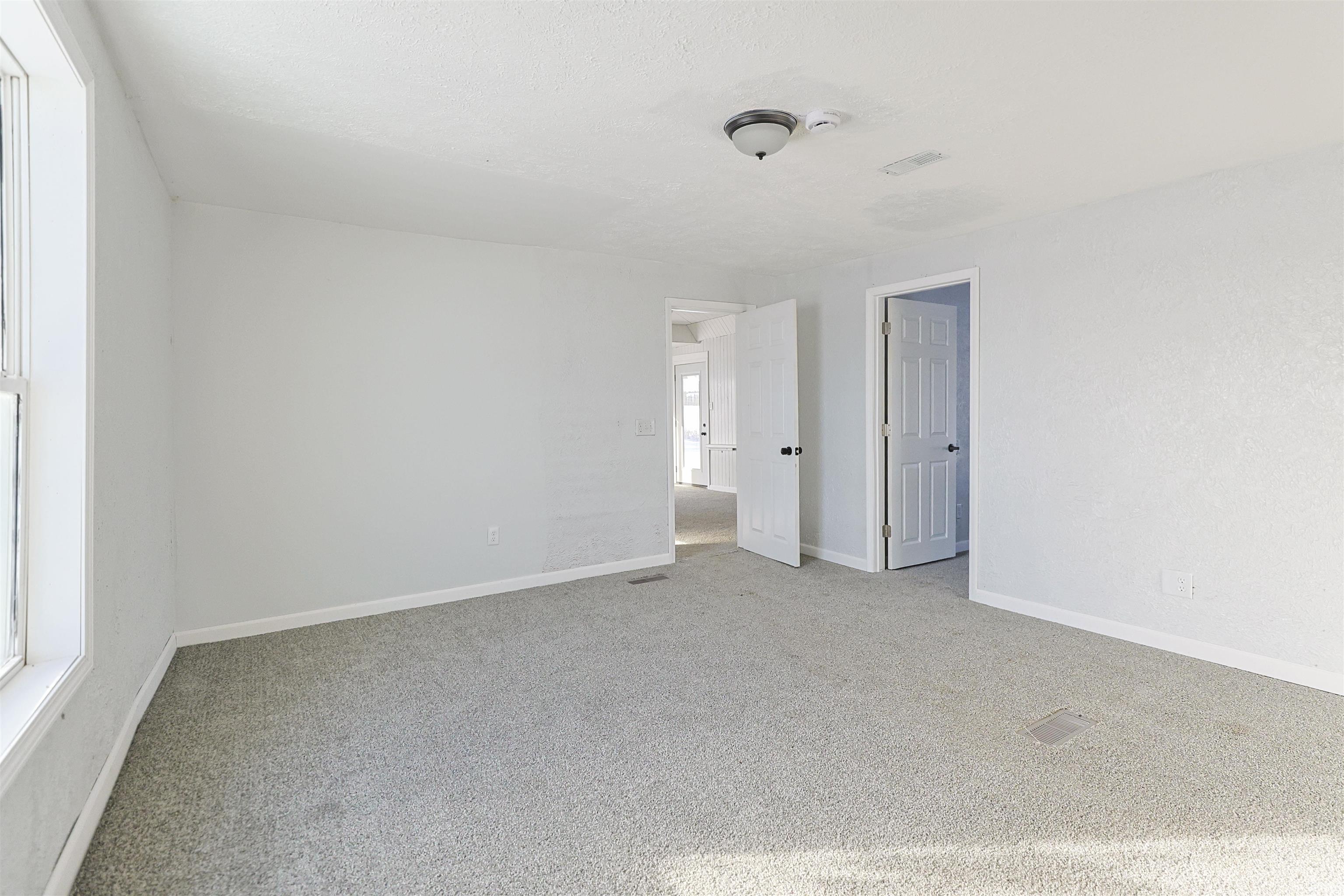 Spare room with carpet floors and baseboards