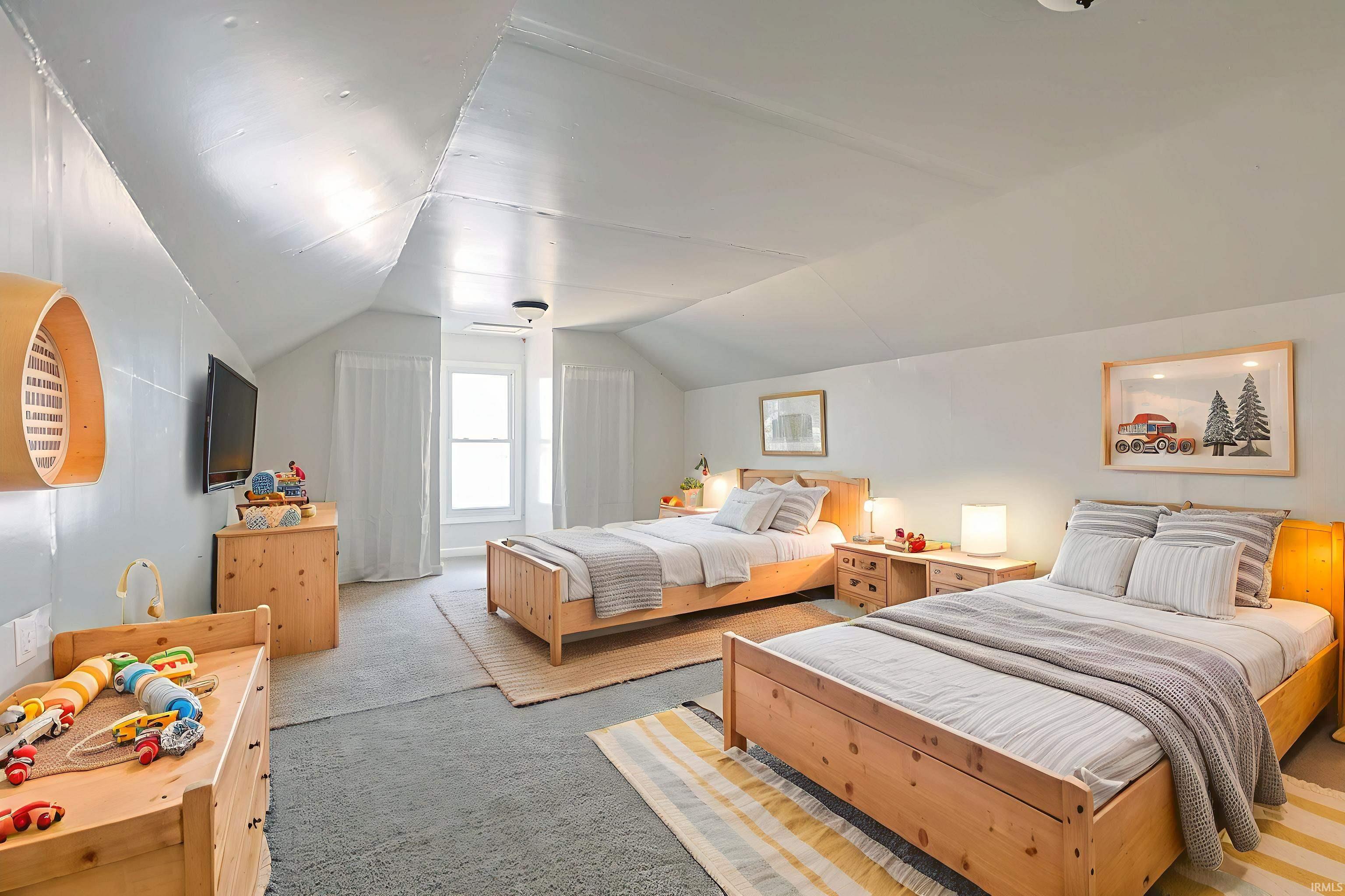 Bedroom featuring lofted ceiling and carpet floors