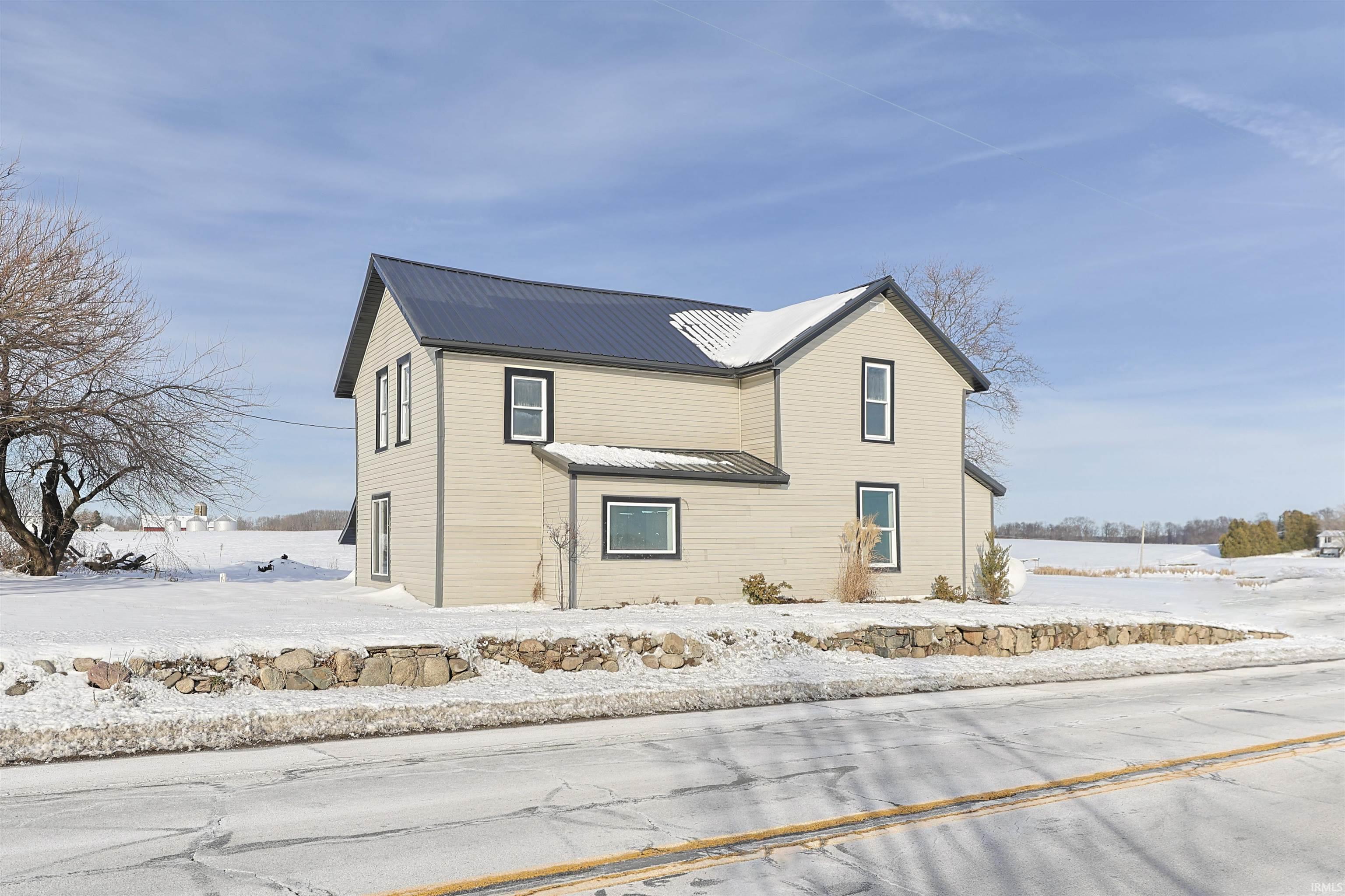 Snow covered property with a metal roof