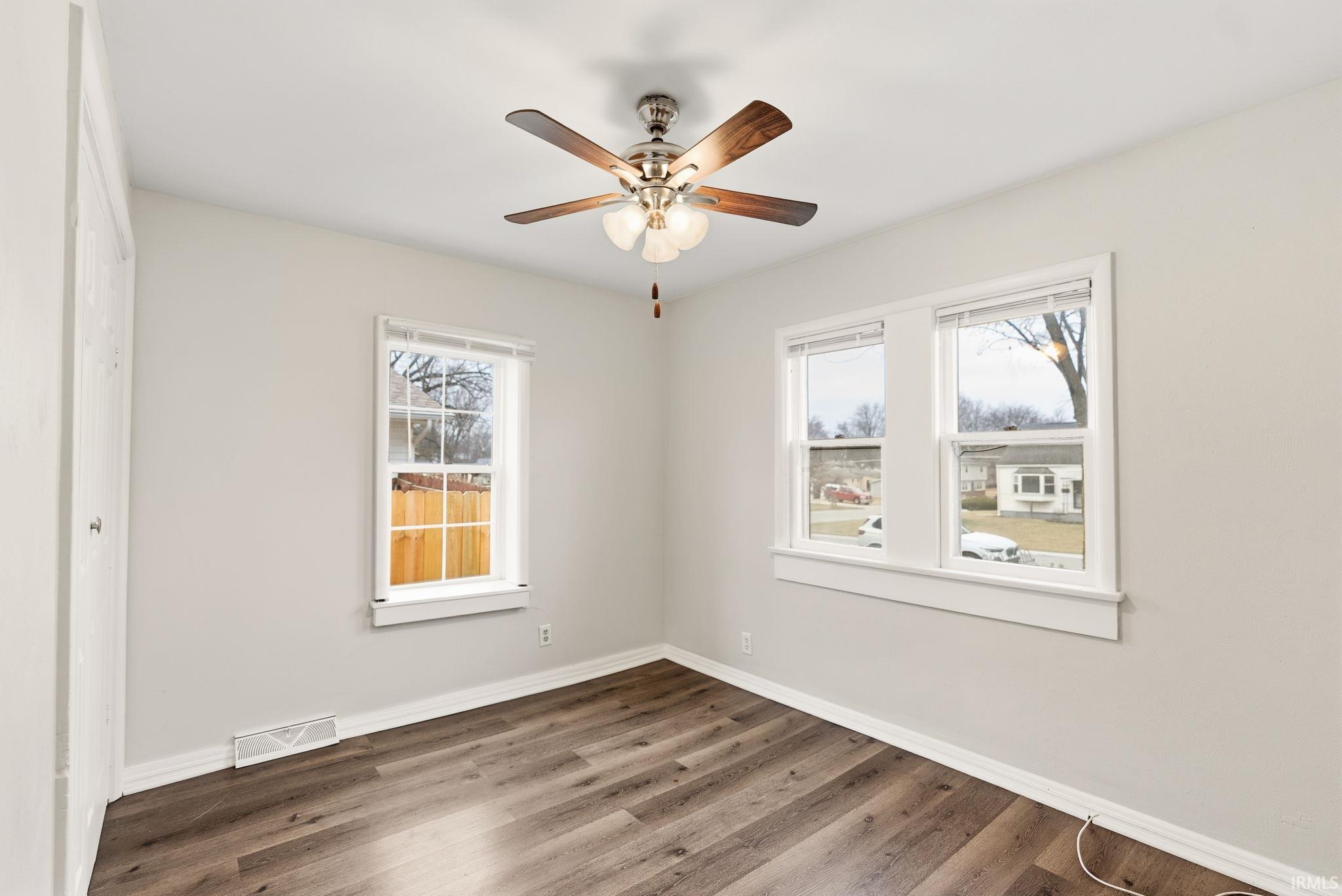 Unfurnished room featuring wood finished floors and ceiling fan