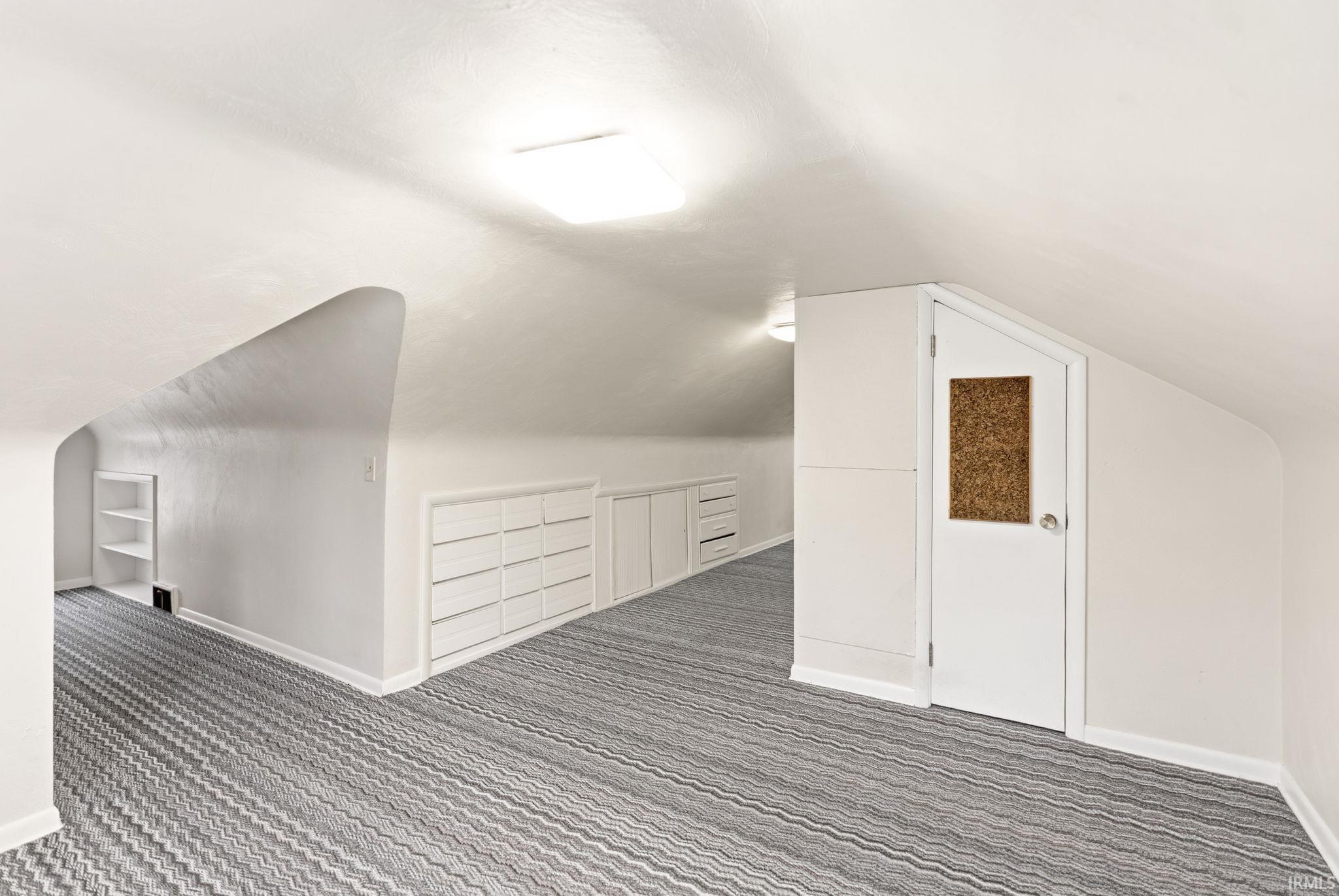 Additional living space with carpet and built in shelves